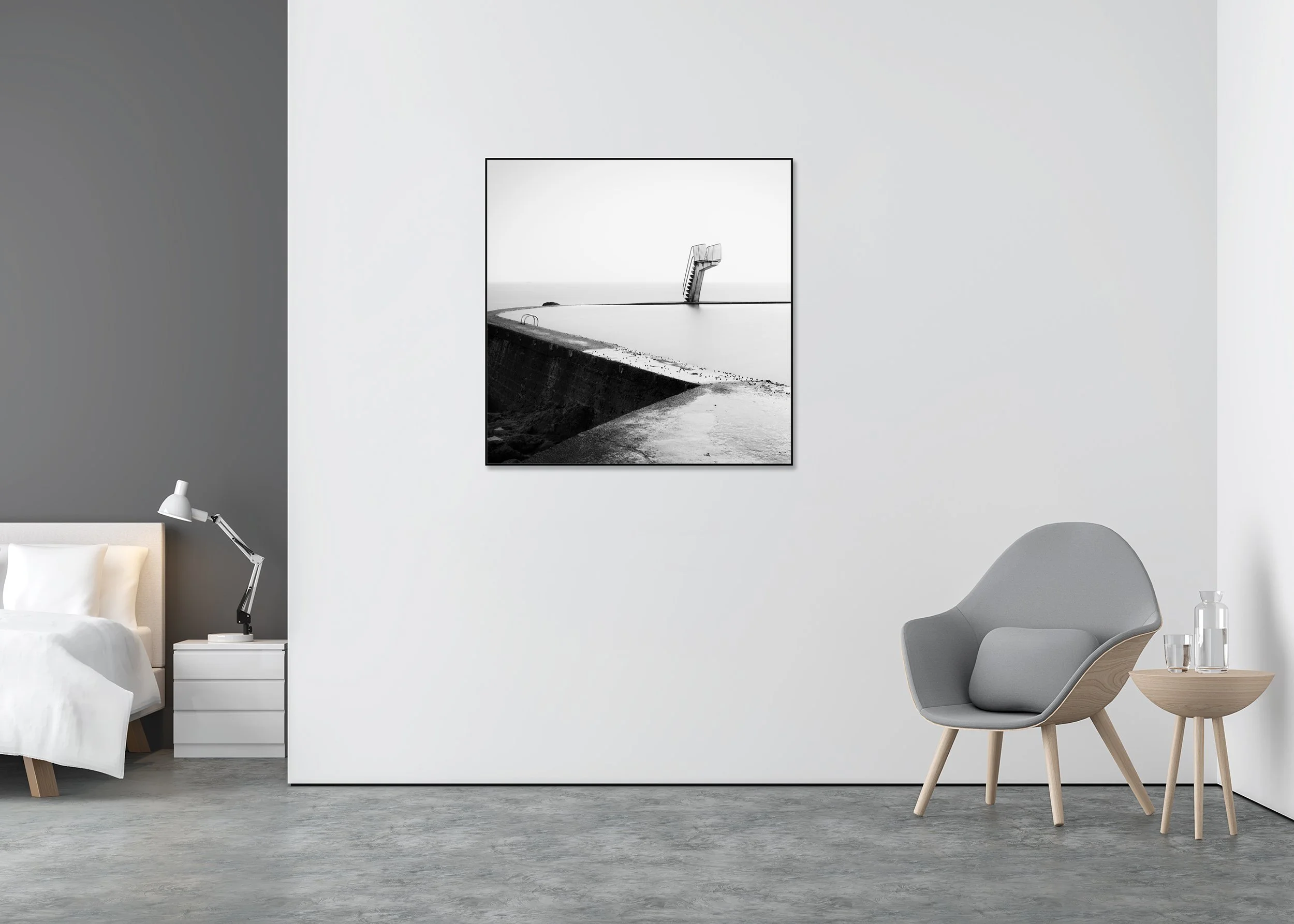 Black-and-white photo print of a calm seawater pool with a single diving platform, mounted to Dibond in an aluminium ArtBox.