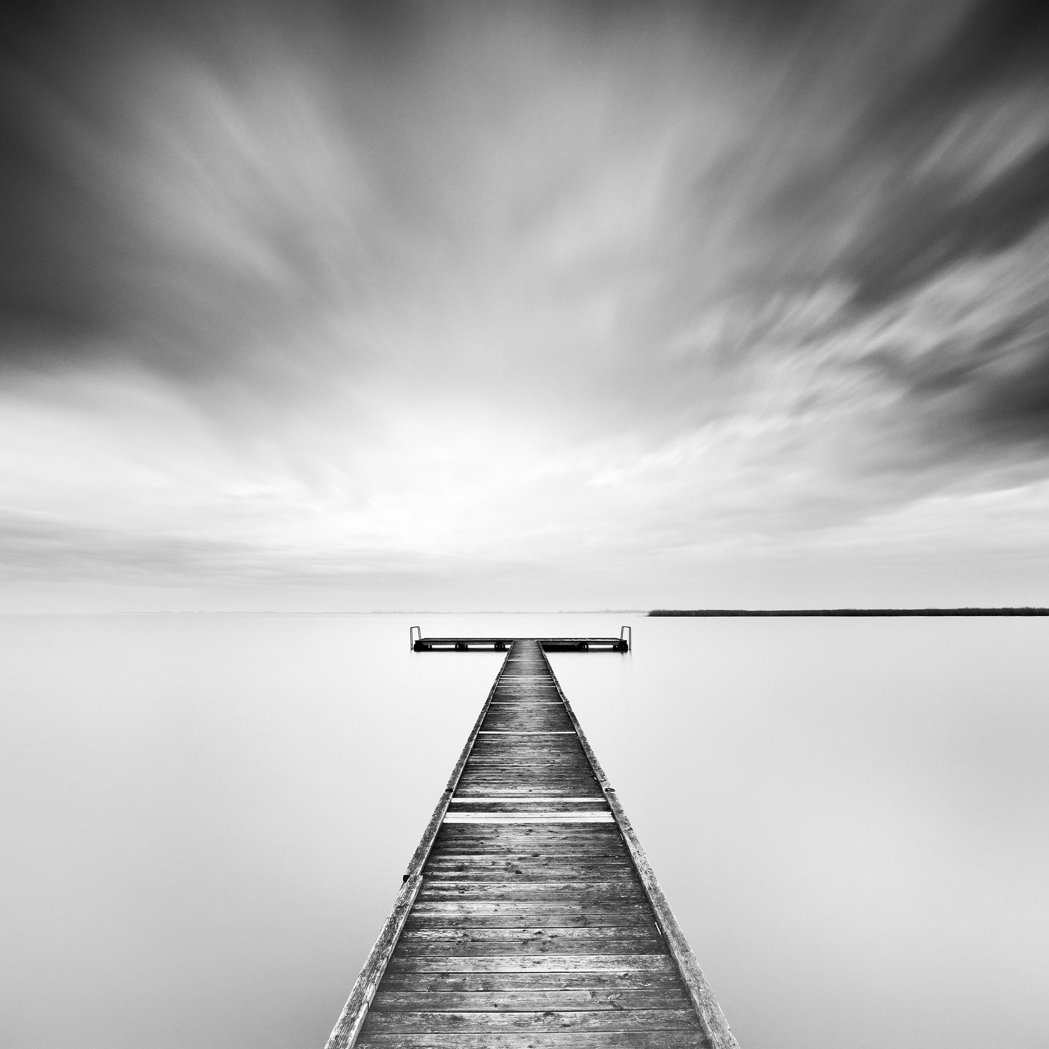 Winter Storm – analogue black-and-white long-exposure photograph of a wooden jetty on Lake Neusiedl, Austria, by Gerald Berghammer.