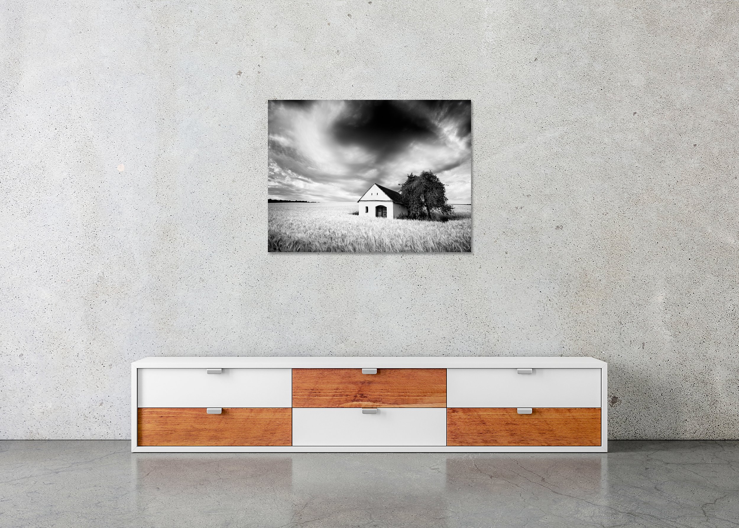 Black-and-white photograph of the Wine Press House in a wheat field beneath dramatic storm clouds, ChromaLuxe metal print, frameless.