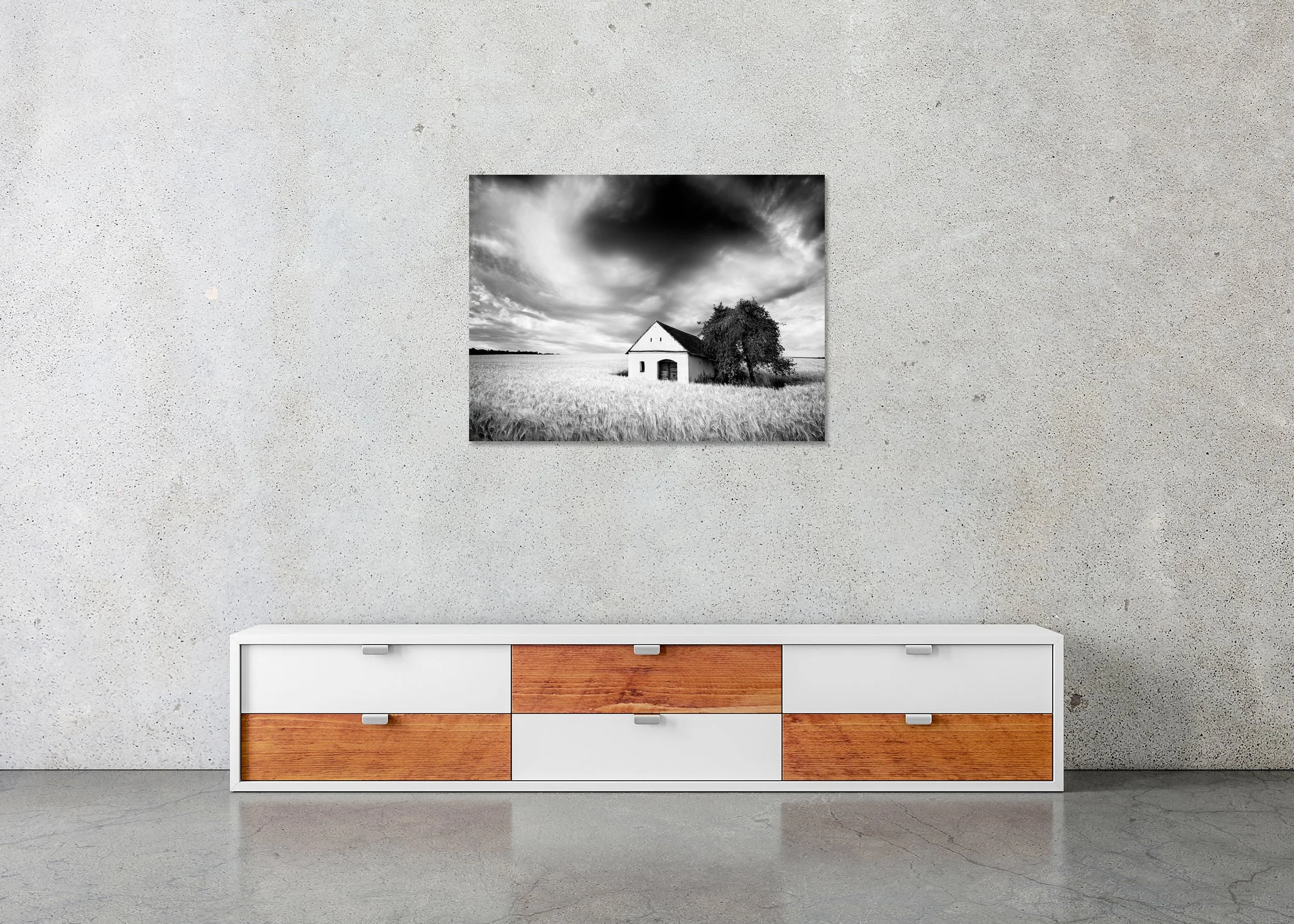 Black-and-white photo of the Wine Press House in a wheat field beneath dramatic storm clouds as a frameless ChromaLuxe metal print