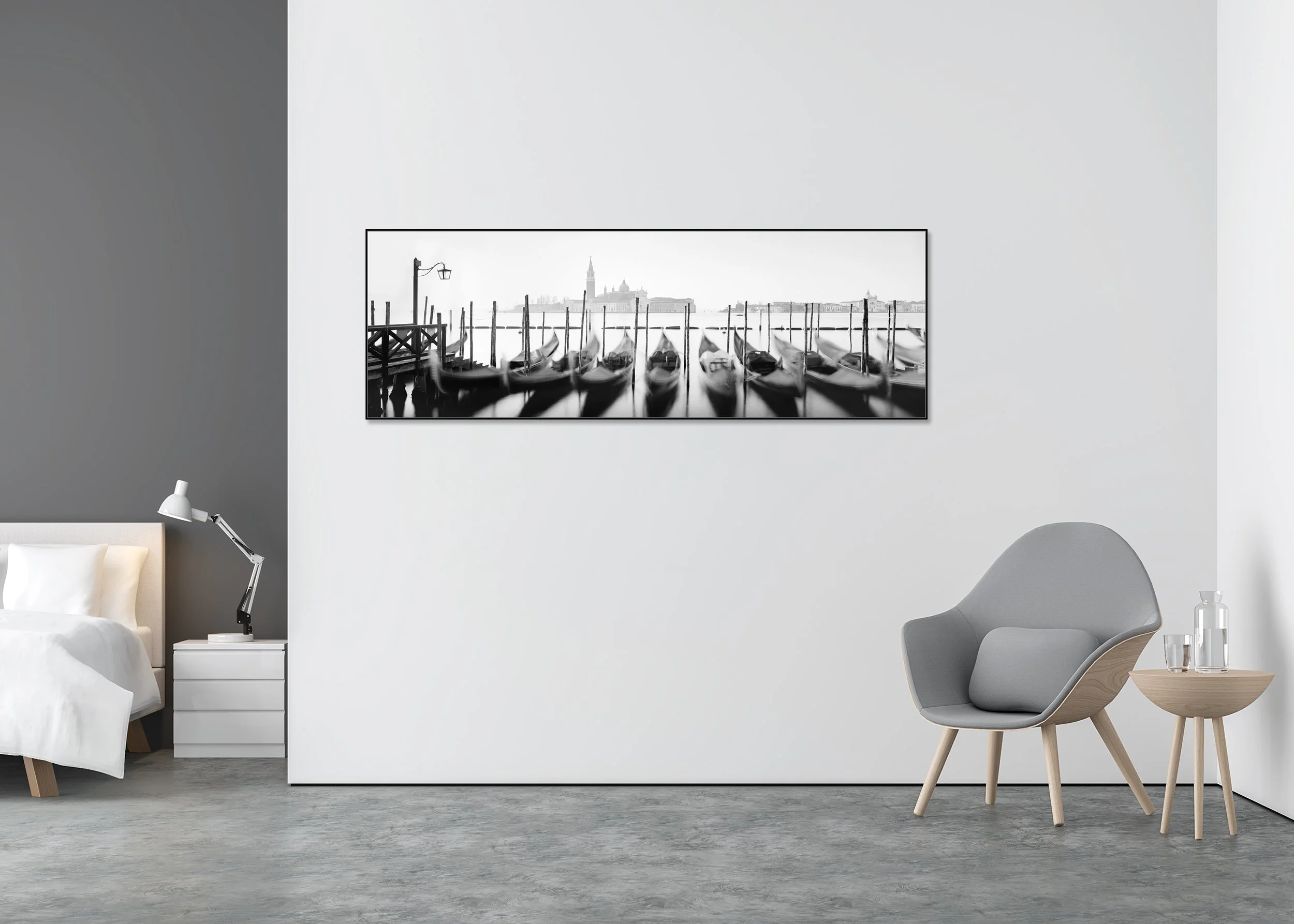 Twelve Gondolas by Gerald Berghammer, black-and-white Venice panorama in a black aluminium ArtBox frame displayed in a minimalist bedroom interior.