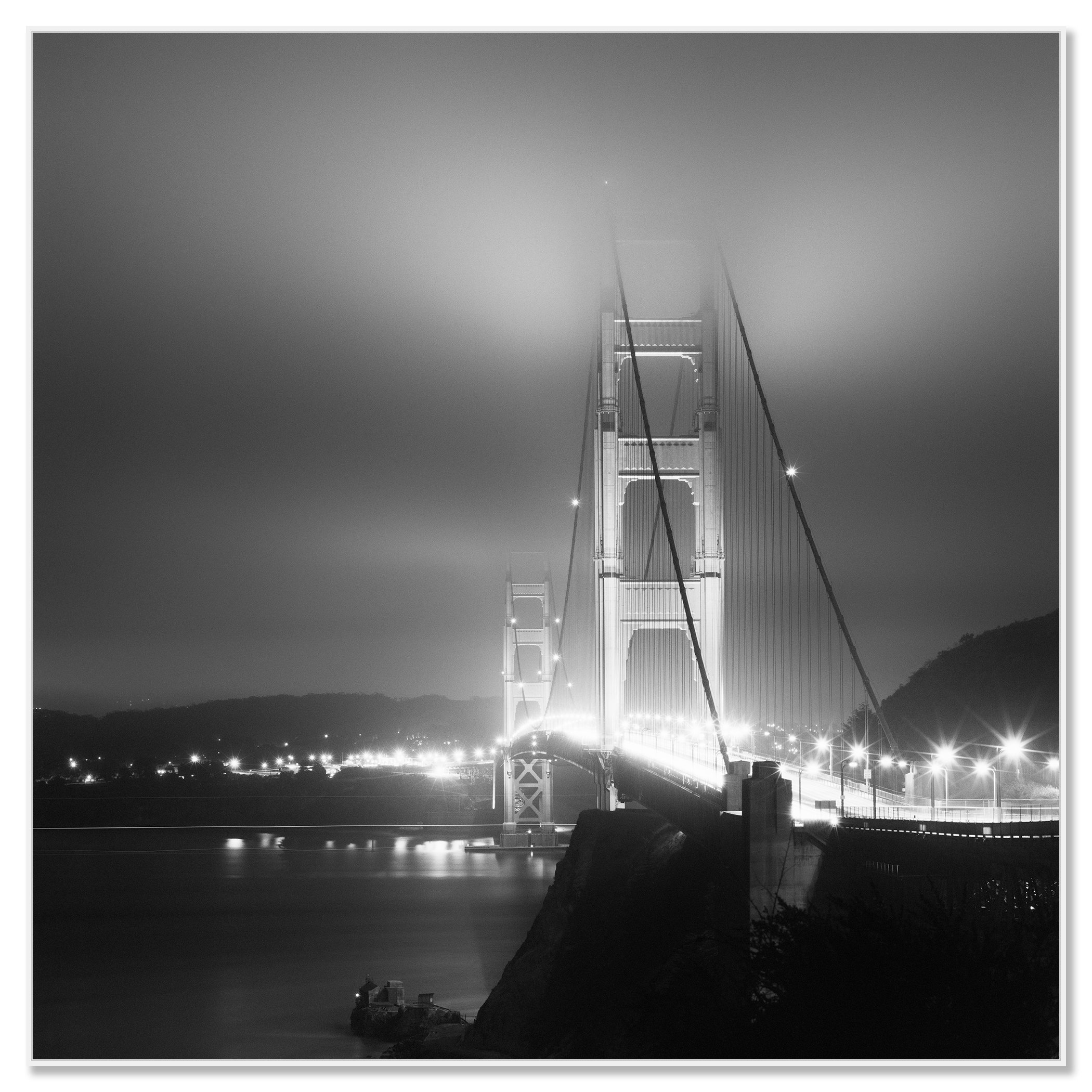 Moody black and white view of the Golden Gate Bridge illuminated at night in San Francisco – framed ArtBox white