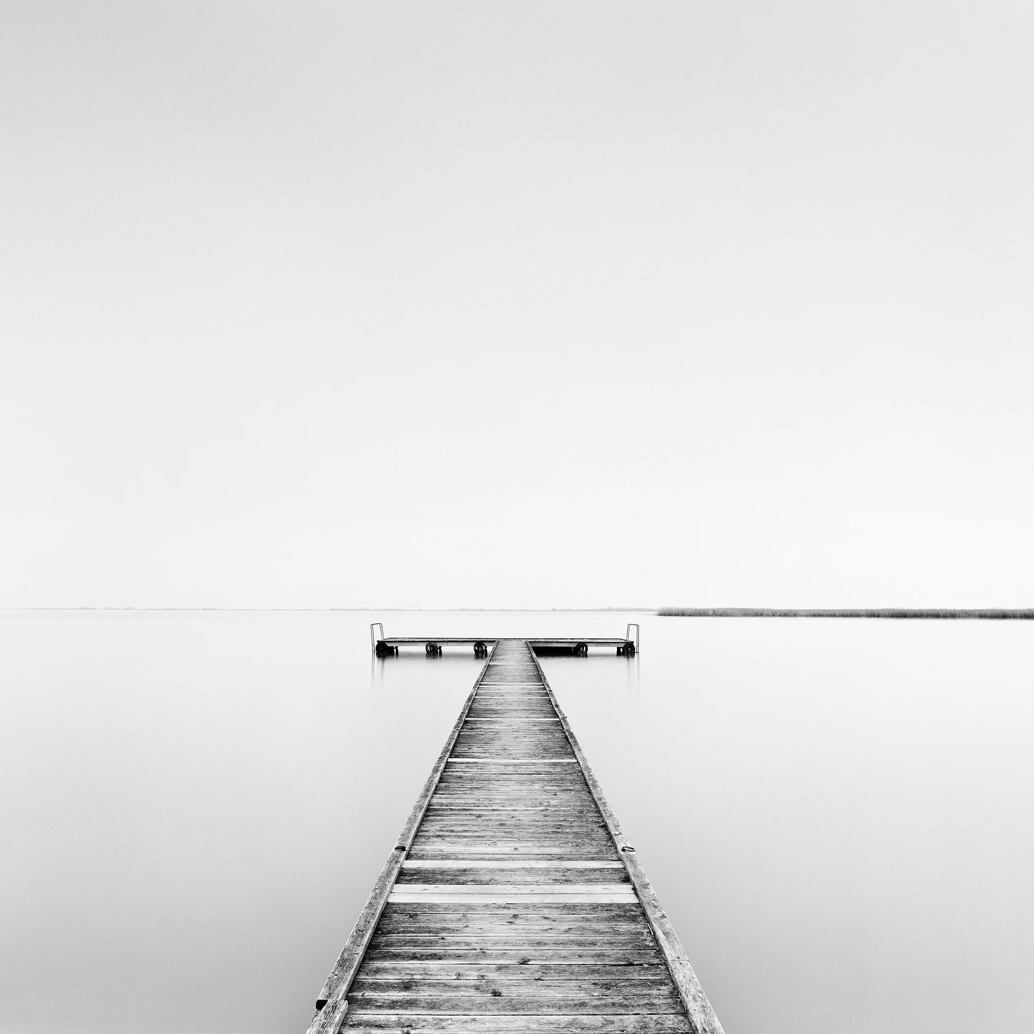 Pier Study 1 – minimalist black-and-white photograph of a wooden pier on Lake Neusiedl, Austria, by Gerald Berghammer.