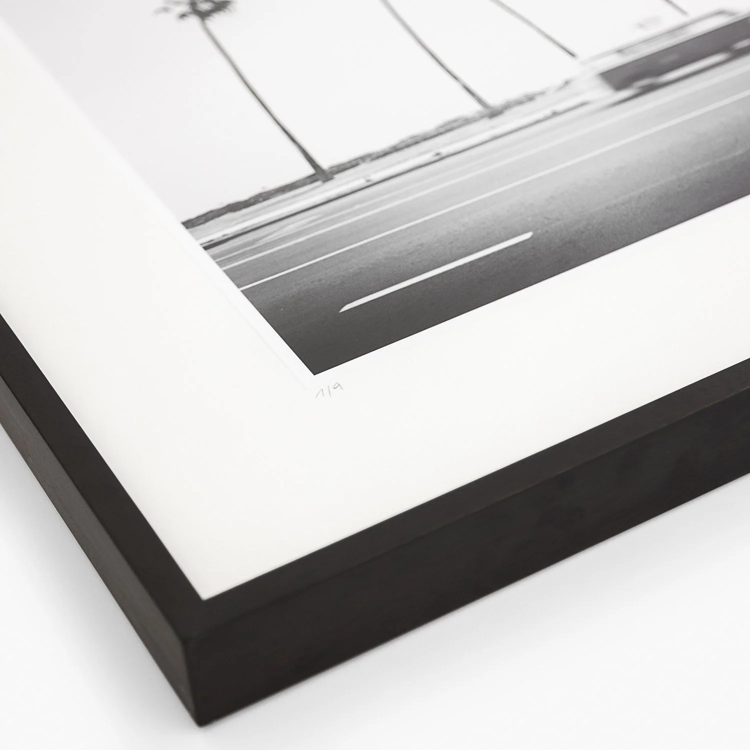 Close-up of the edition number 1/9 on the archival mount of VW Bus T2 by Gerald Berghammer, presented in a dark-brown wooden frame.