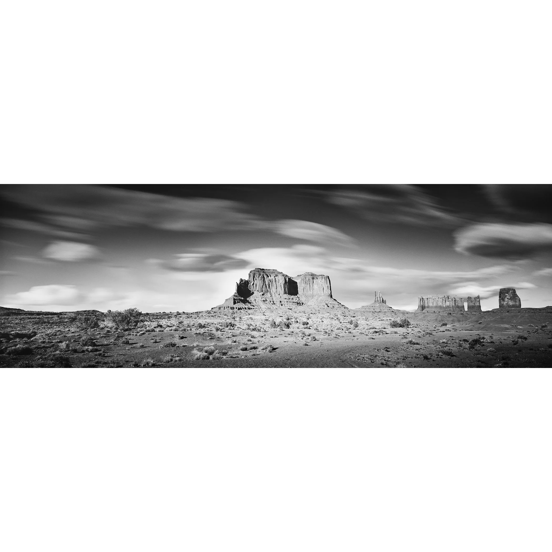 © 2015 Gerald Berghammer - Black and white photography. Landscape of rugged desert terrain with large rock formations and scattered vegetation under a cloudy sky.