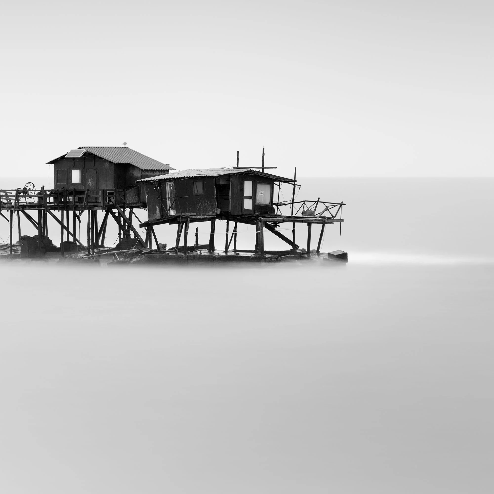 Detail of Marina di Pisa Study 1 showing the right-hand stilt fishing hut above the calm sea in Tuscany, Italy, by Gerald Berghammer.