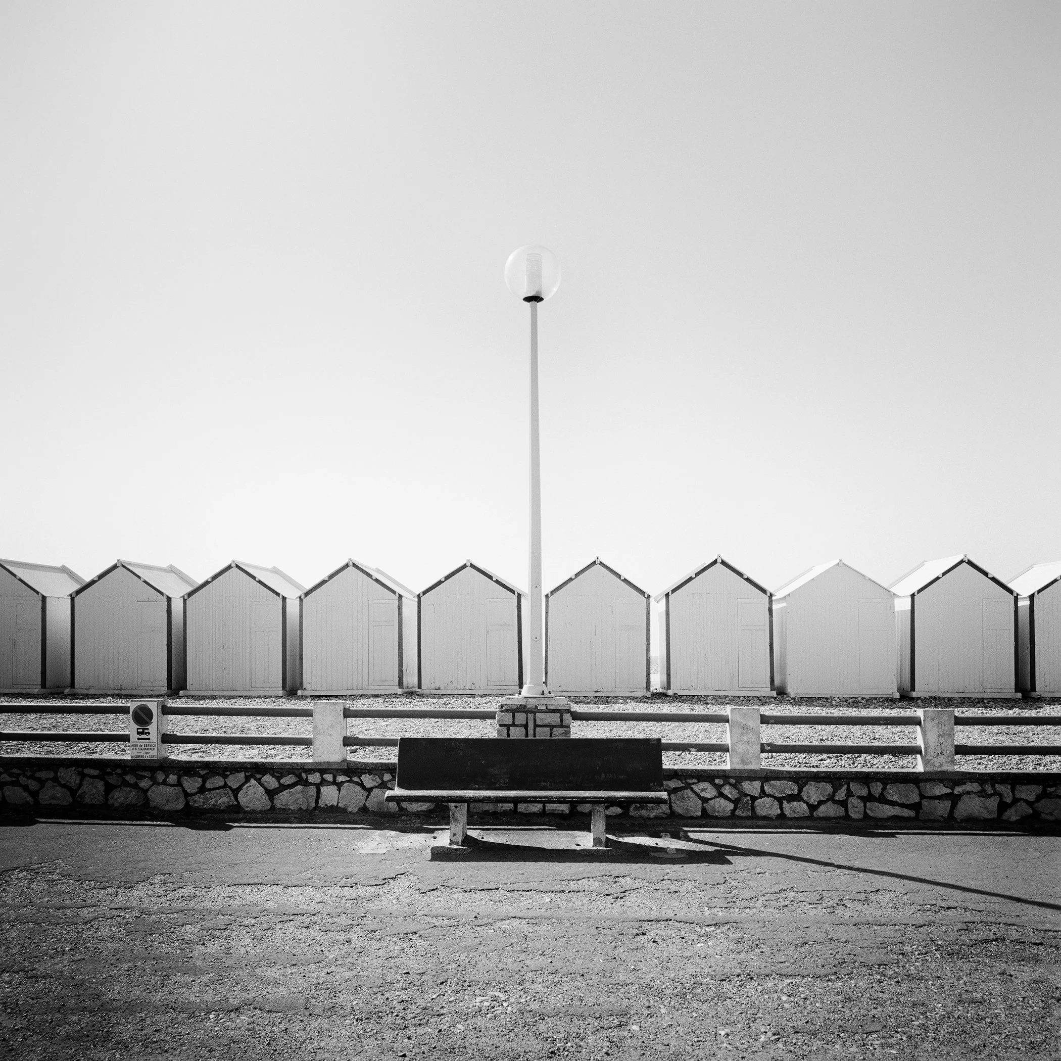 Full view of Bench on the Promenade Study 1, an analogue black-and-white coastal photograph made in France by Gerald Berghammer.