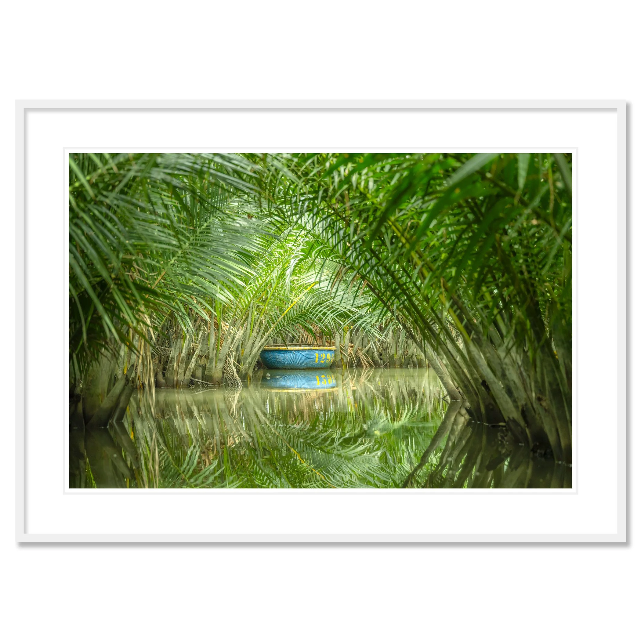 © 2025 Gerald Berghammer - Color waterscape photography. A small coconut boat among dense green nipa palm trees on a calm water body, with its reflection visible. Classic framed white