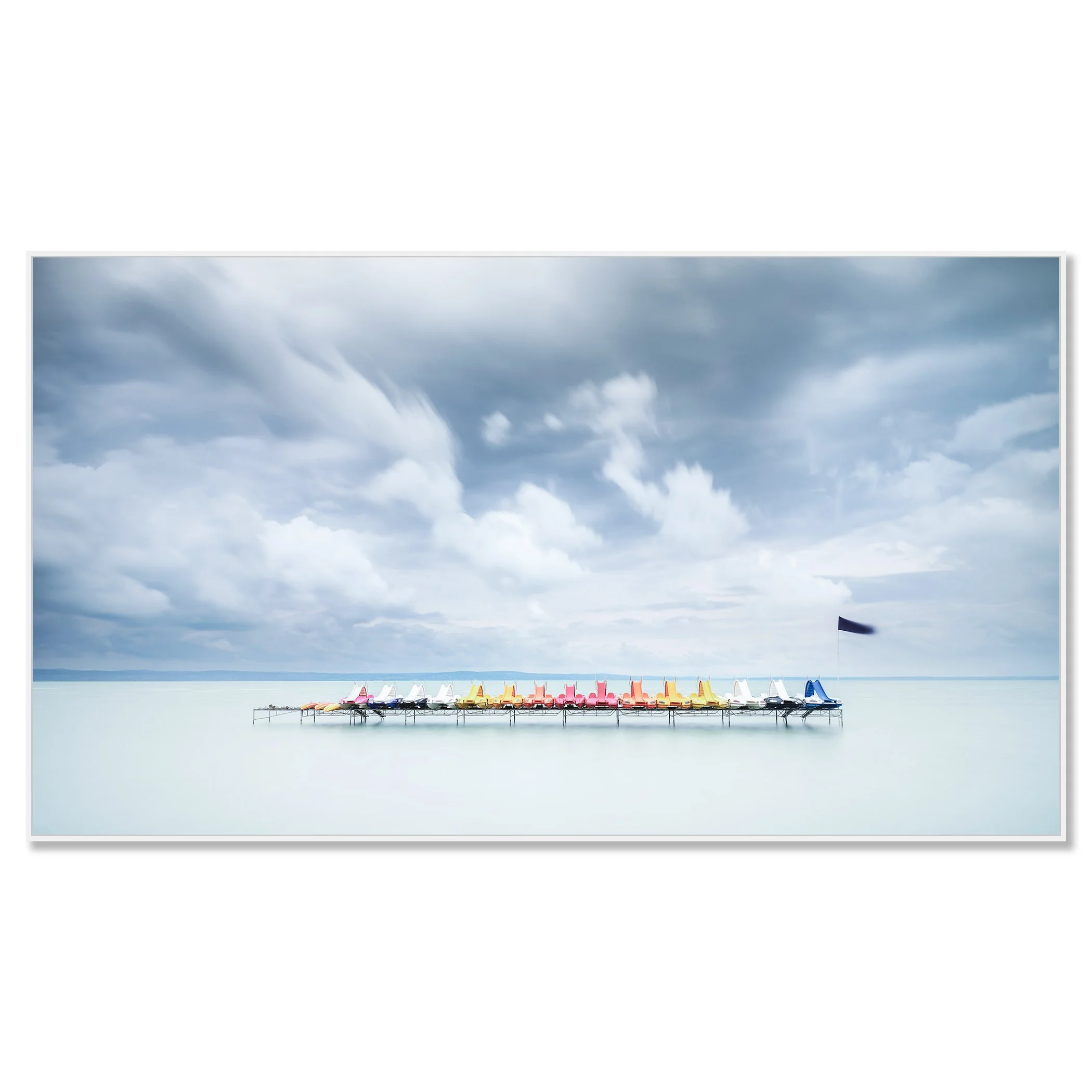 Gerald Berghammer - Color long exposure waterscape photography. Colorful paddle boats lined up on a dock over calm water, under a cloudy sky. Chromaluxe framed white