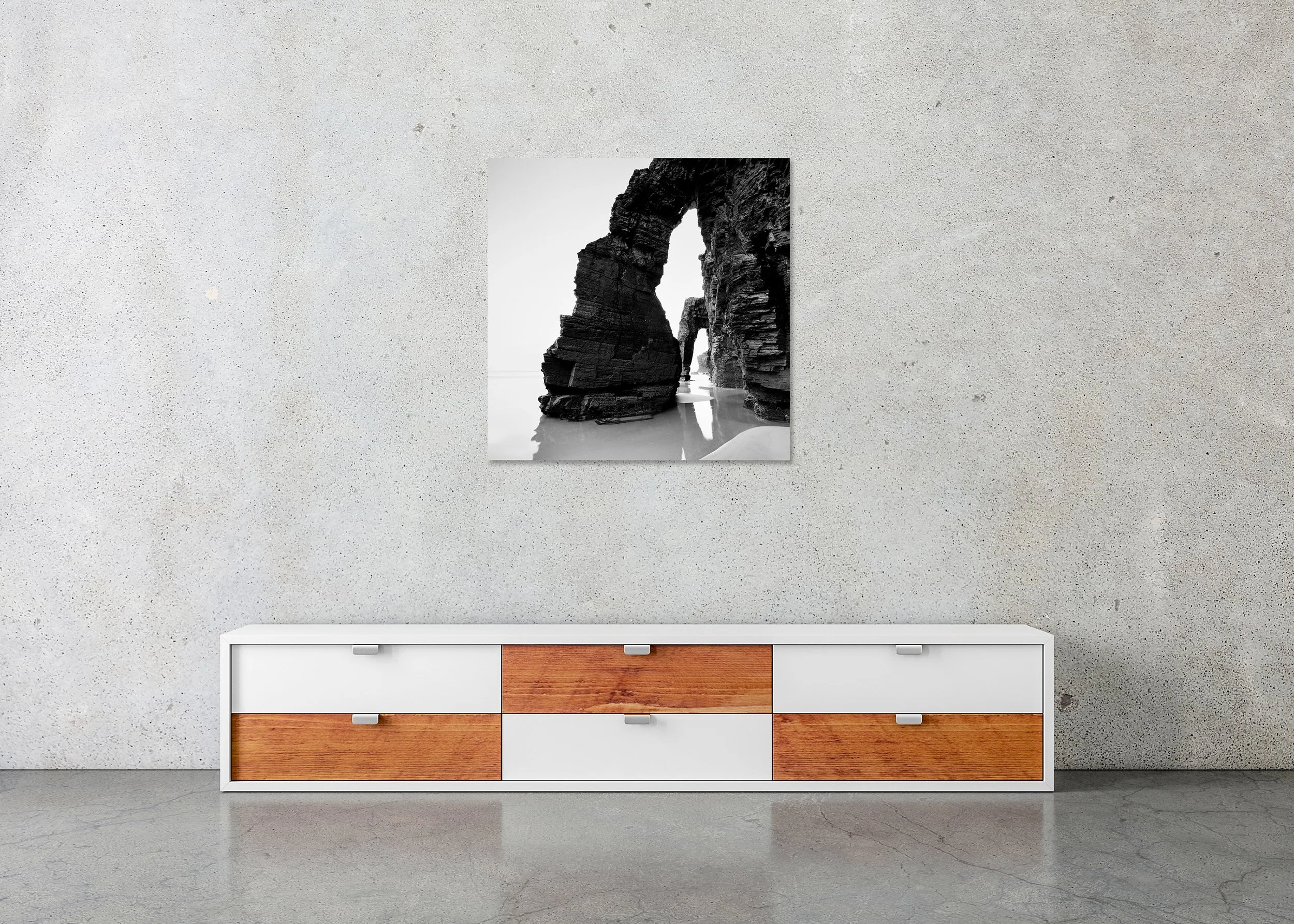Arches on Catedrais Beach Study 4 displayed in a modern interior as a frameless black-and-white aluminium Dibond print by Gerald Berghammer.