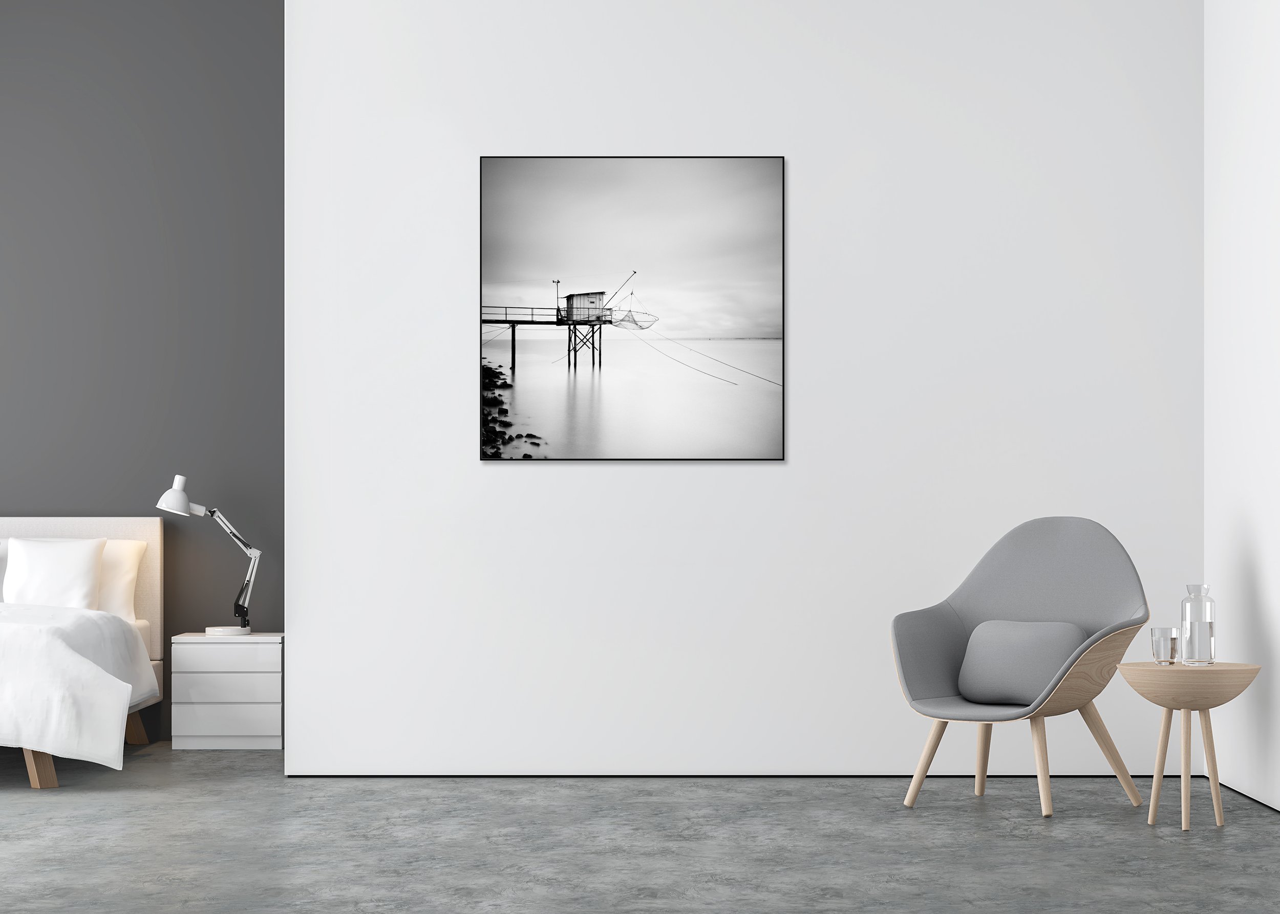 Minimalist black-and-white long-exposure photo of a traditional fishing hut on stilts with nets over a calm sea, ChromaLuxe metal print in an aluminium ArtBox frame.