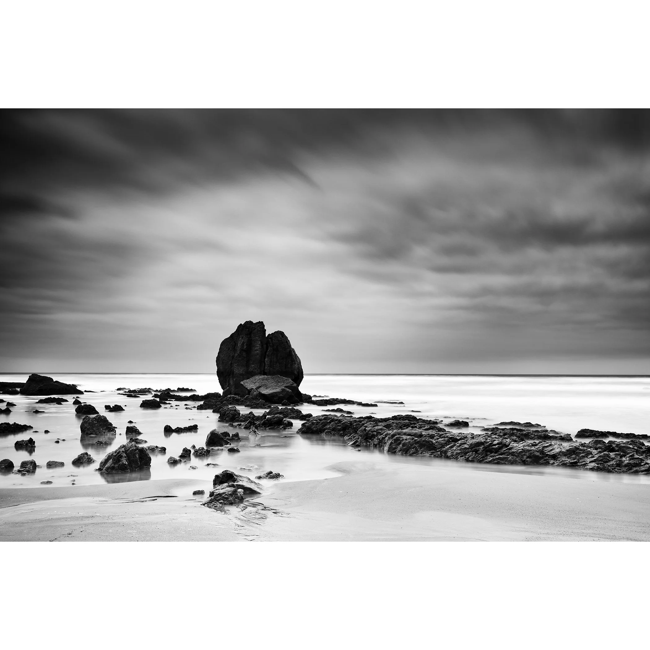 Rocks on the Shore Study 1 by Gerald Berghammer, minimalist black-and-white long-exposure seascape of a monumental rock formation on the Atlantic coast of France.