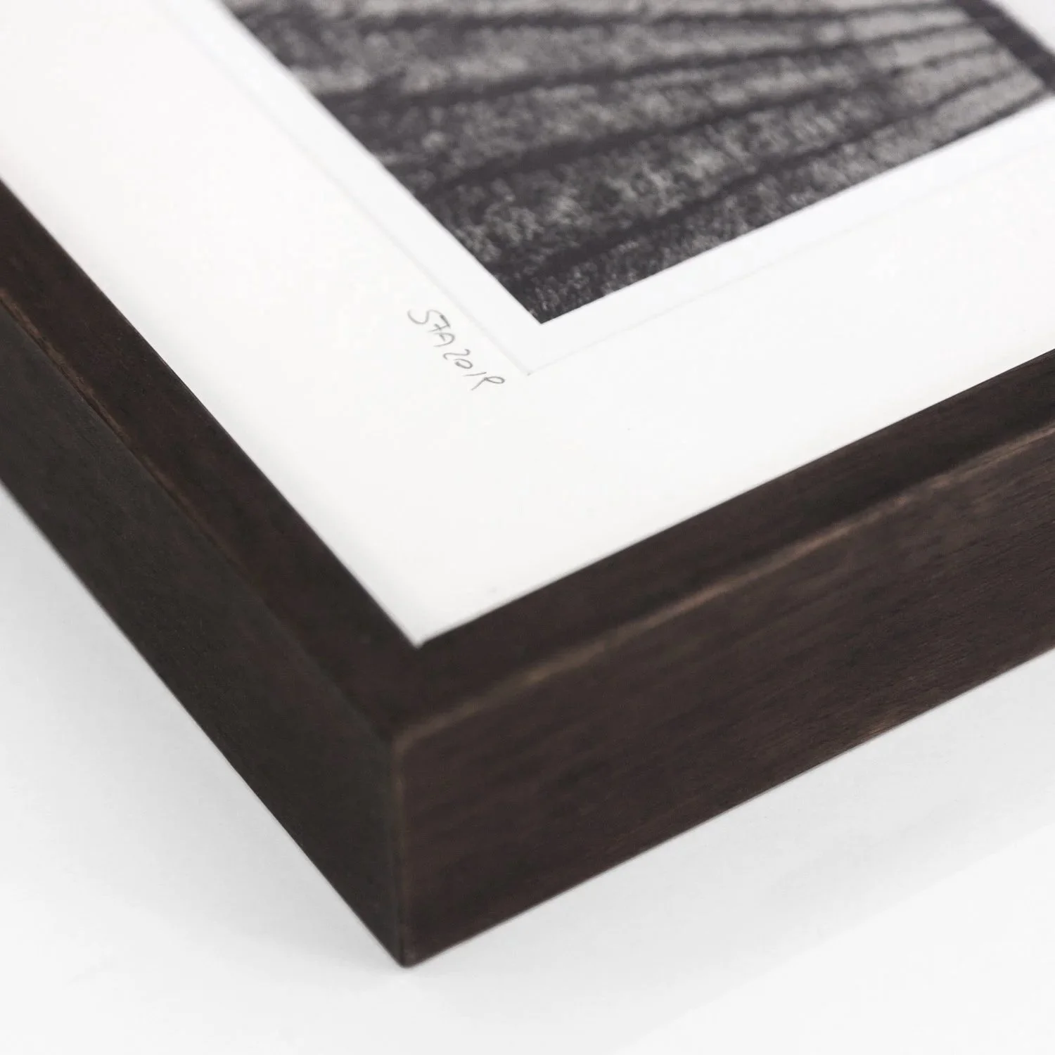 Close-up of Champagne Paradise by Gerald Berghammer, showing the dark-brown wooden frame, white archival mount and handwritten inscription.