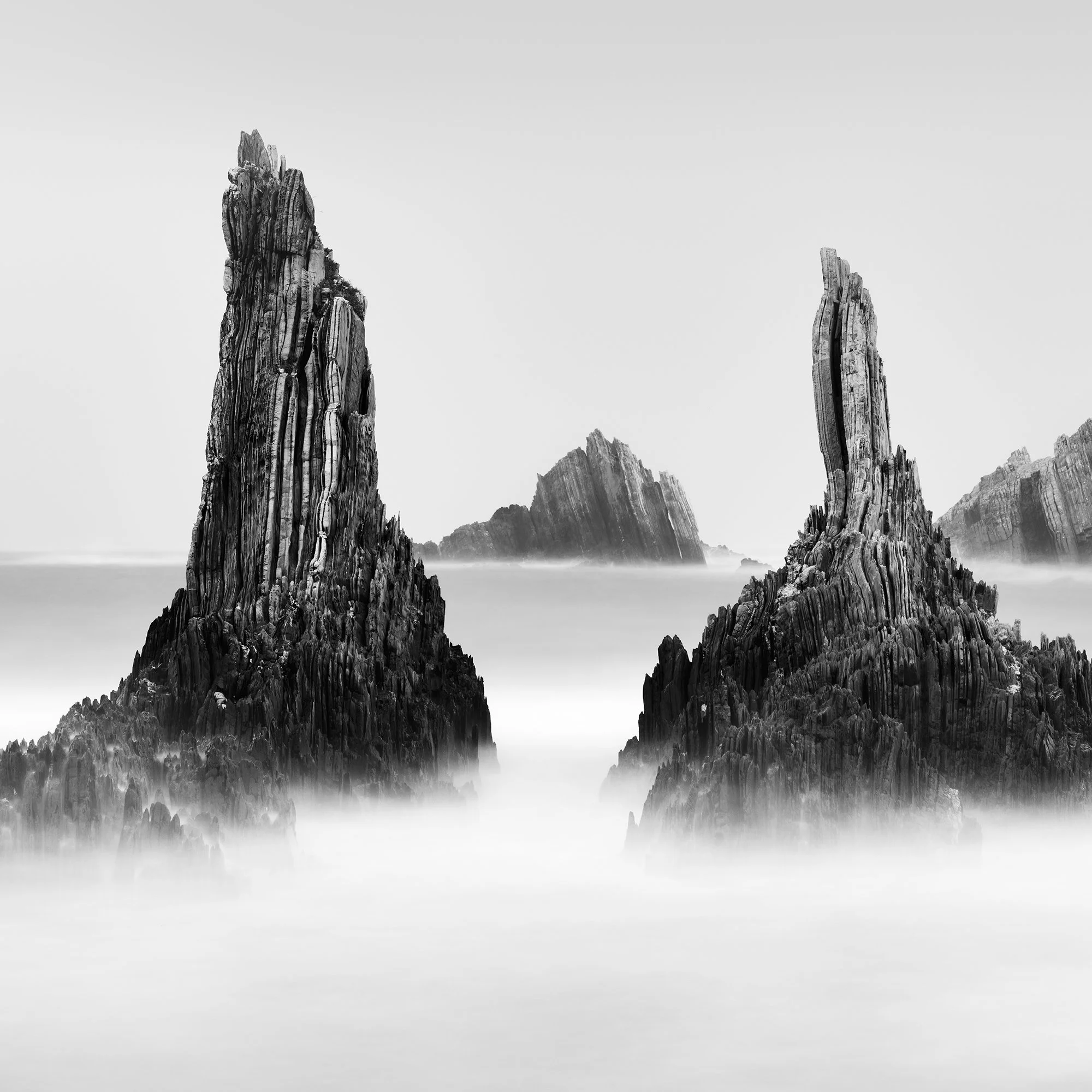 Detail of Rocky Peaks Panorama Study 5 by Gerald Berghammer showing two dramatic sea stacks rising from the Atlantic Ocean in Spain.
