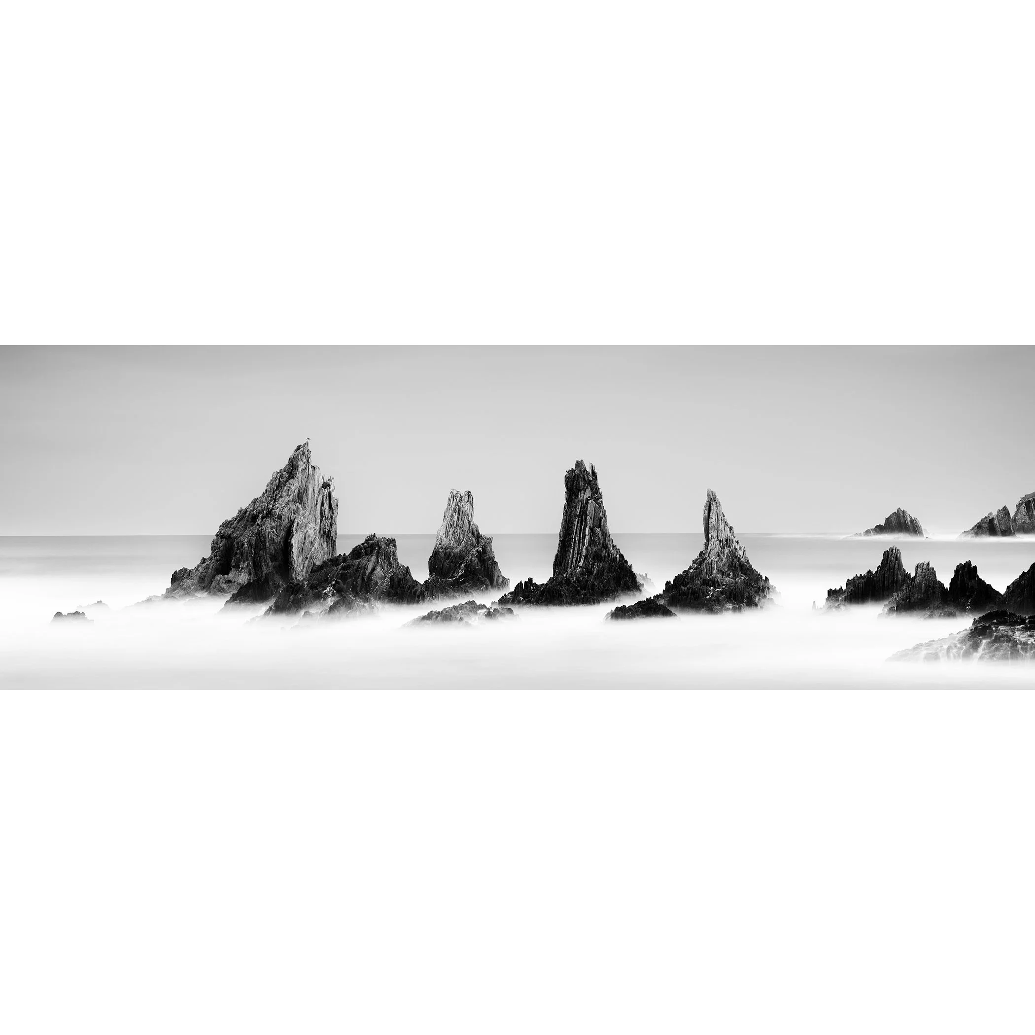 Rocky Peaks, Panorama Study 3 – panoramic black-and-white seascape of jagged Atlantic sea stacks in northern Spain by Gerald Berghammer.
