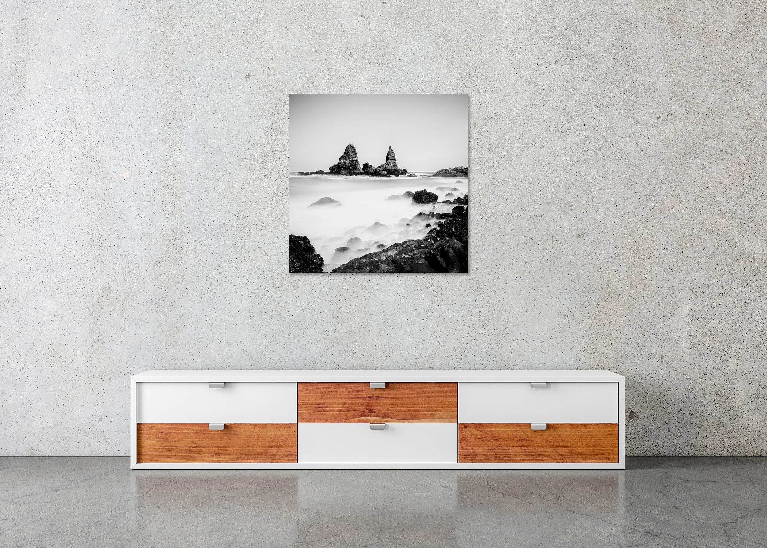 Black-and-white seascape with jagged sea stacks and misty surf over a rocky shore, photo print mounted to Dibond, frameless.