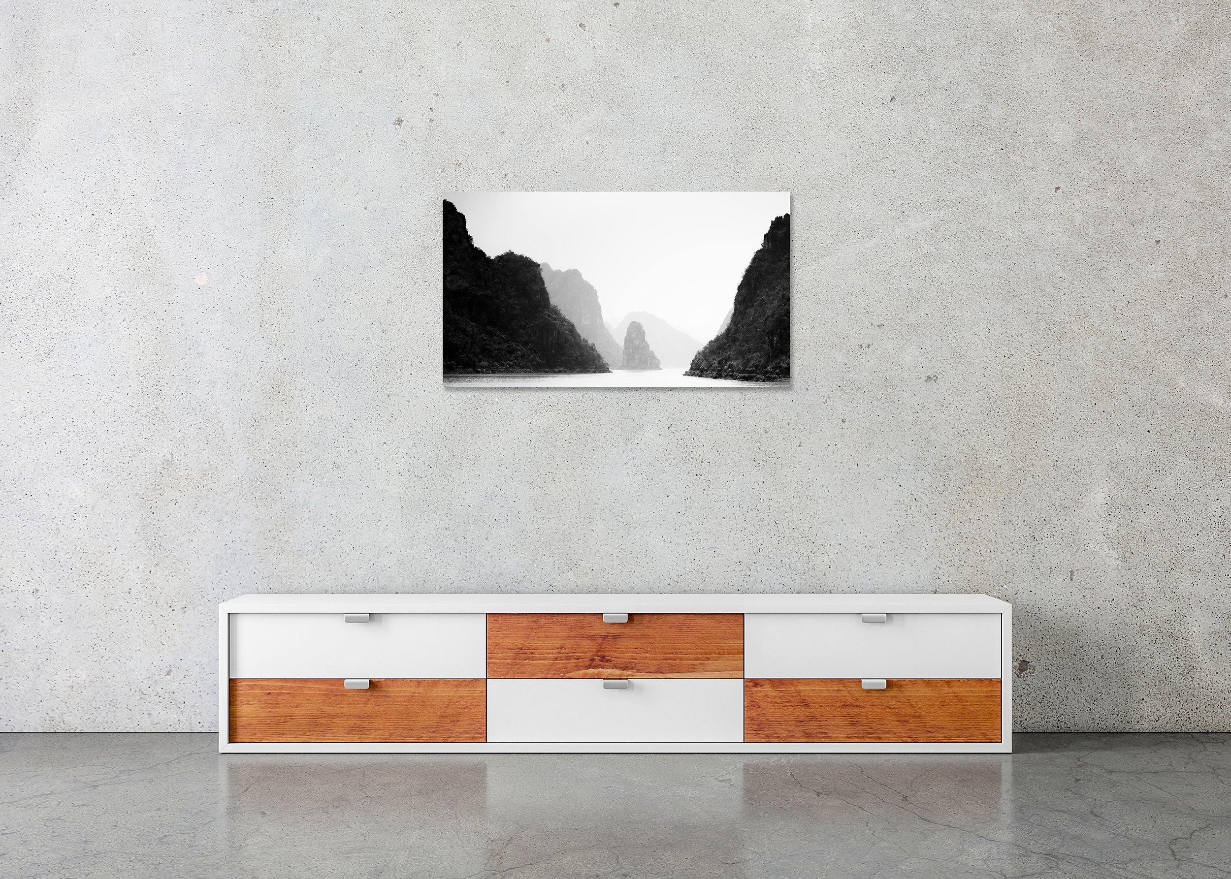 Black-and-white minimalist photograph of misty limestone karsts rising from calm water in Ha Long Bay, Vietnam. ChromaLuxe Metal Print – Frameless