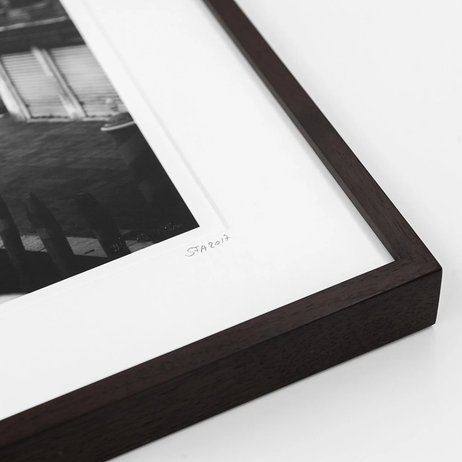 Detail of Canal Grande Study 1 by Gerald Berghammer, showing the dark-brown wooden frame, white archival mount and handwritten inscription.