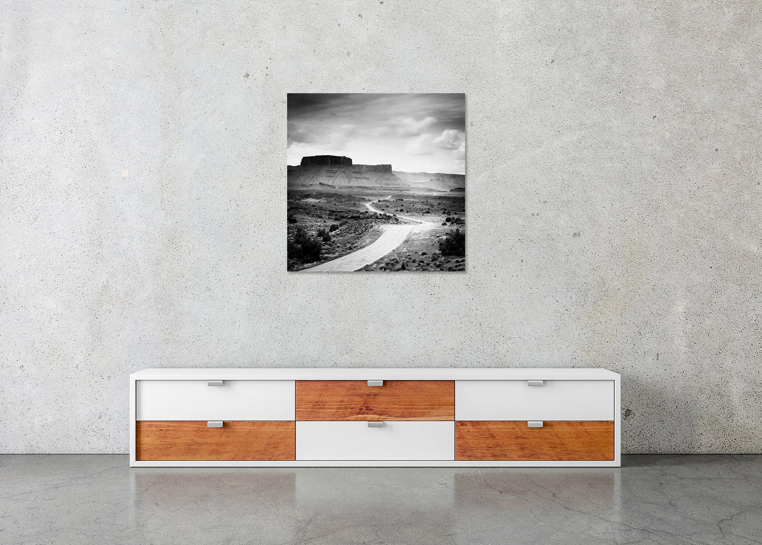 Road to Nowhere – Utah, USA, frameless black-and-white photograph on aluminium Dibond displayed in a minimalist interior. Photo by Gerald Berghammer.