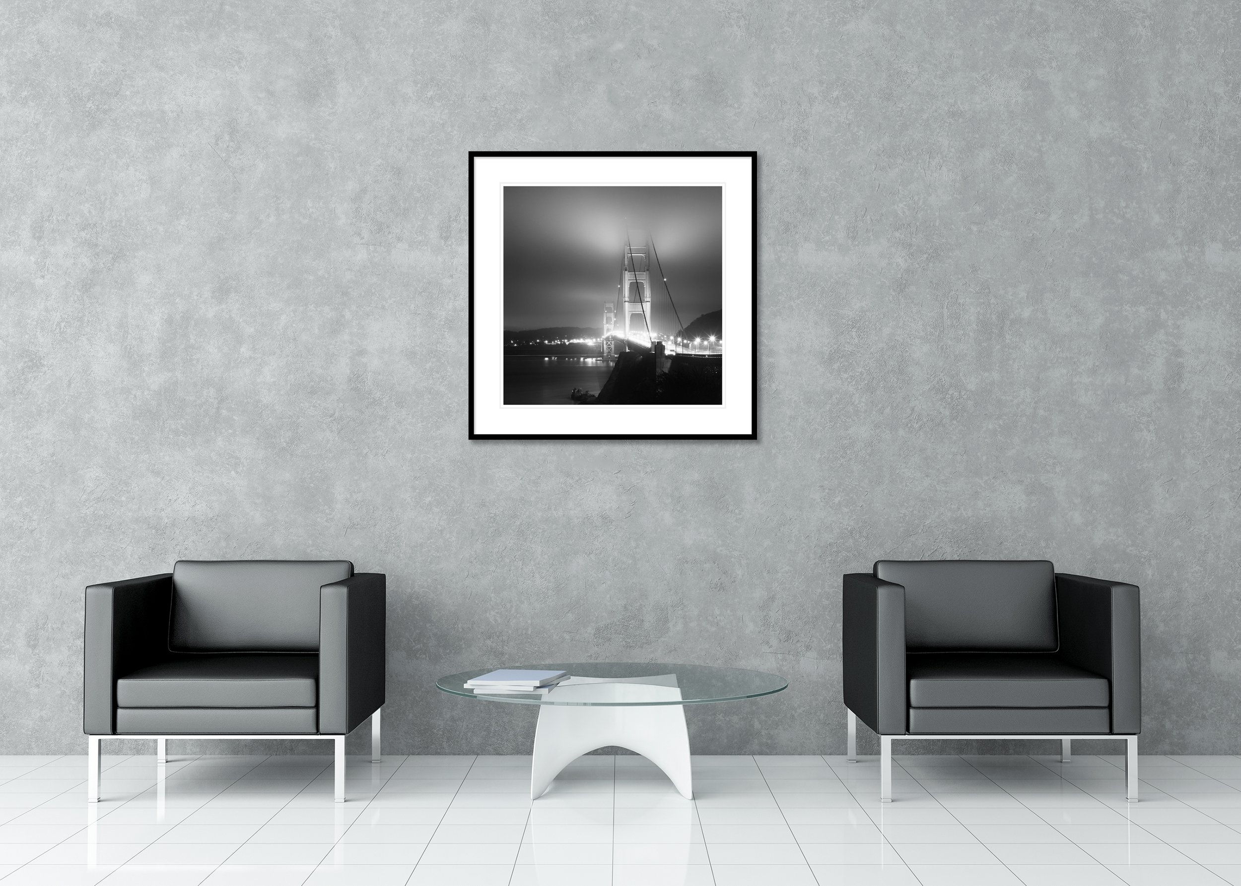 Monochrome Golden Gate Bridge at night with foggy sky, bright lights and calm water, archival pigment print in a classic frame with mount