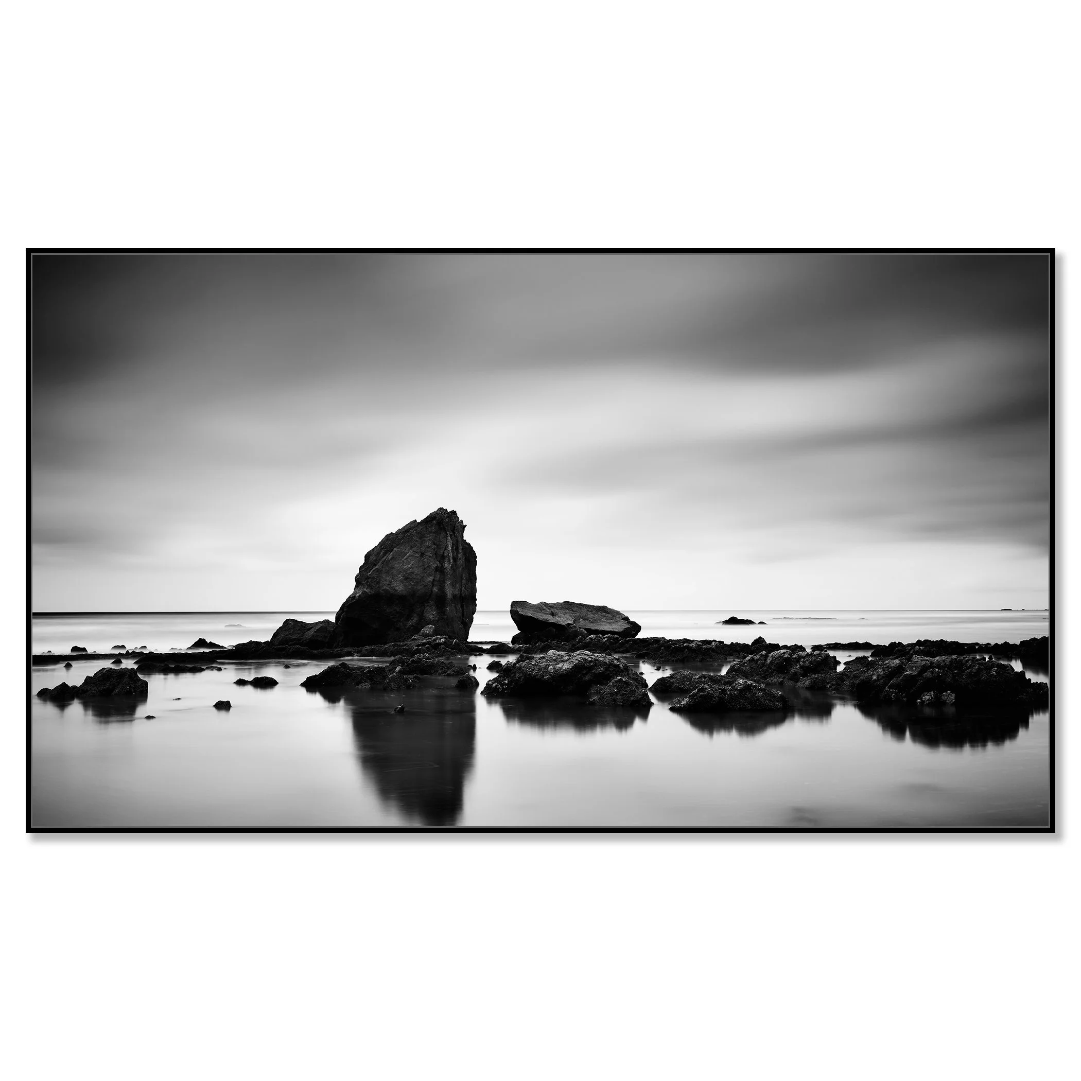 © 2023 Gerald Berghammer - Black and white minimalist beach seascape. A rocky shoreline with a large prominent rock formation in the water. Chromaluxe framed black