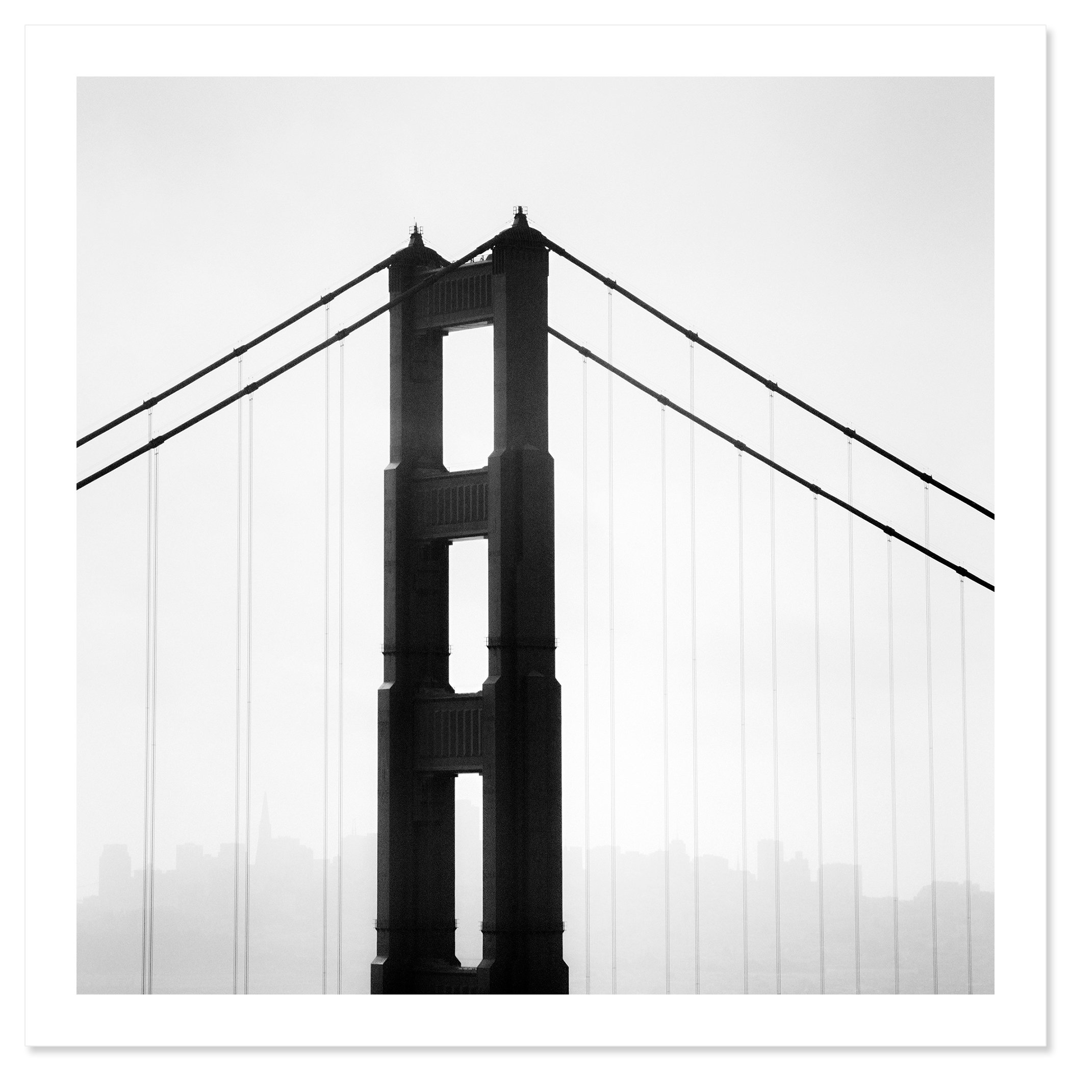 © 2015 Gerald Berghammer - Black and white photo. Golden Gate Bridge in San Francisco, seen from the side, with the city skyline faintly visible in the background. Fine art print only