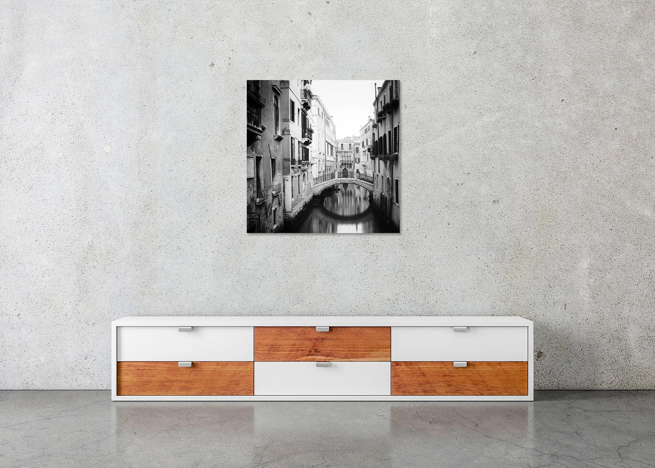 The Bridges of Venice, Study 2 – frameless black-and-white photograph on aluminium Dibond displayed above a low cabinet.