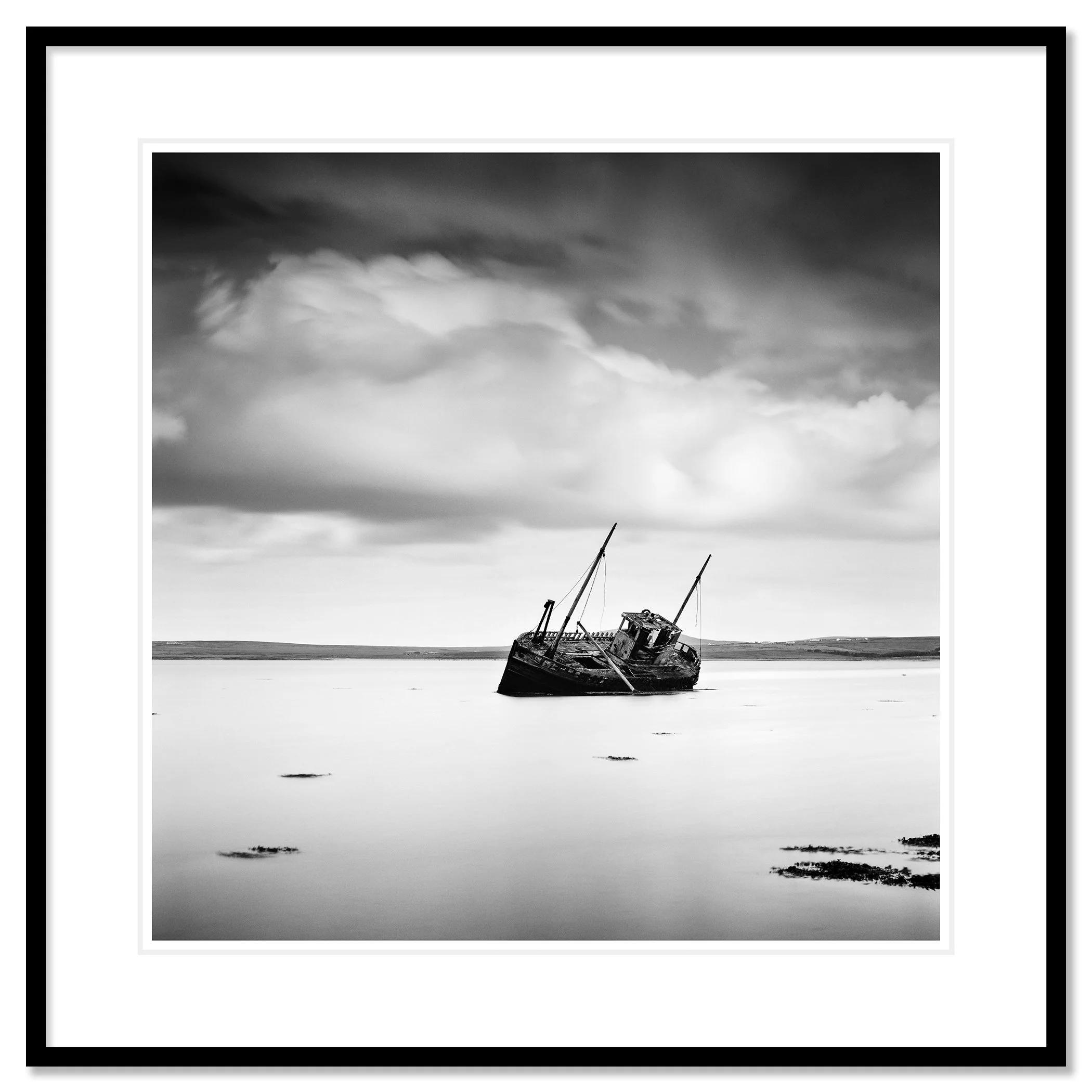 © 2014 Gerald Berghammer - Black and white minimalist seascape photography. An abandoned boat stuck in shallow water with cloudy sky overhead. Classic framed black