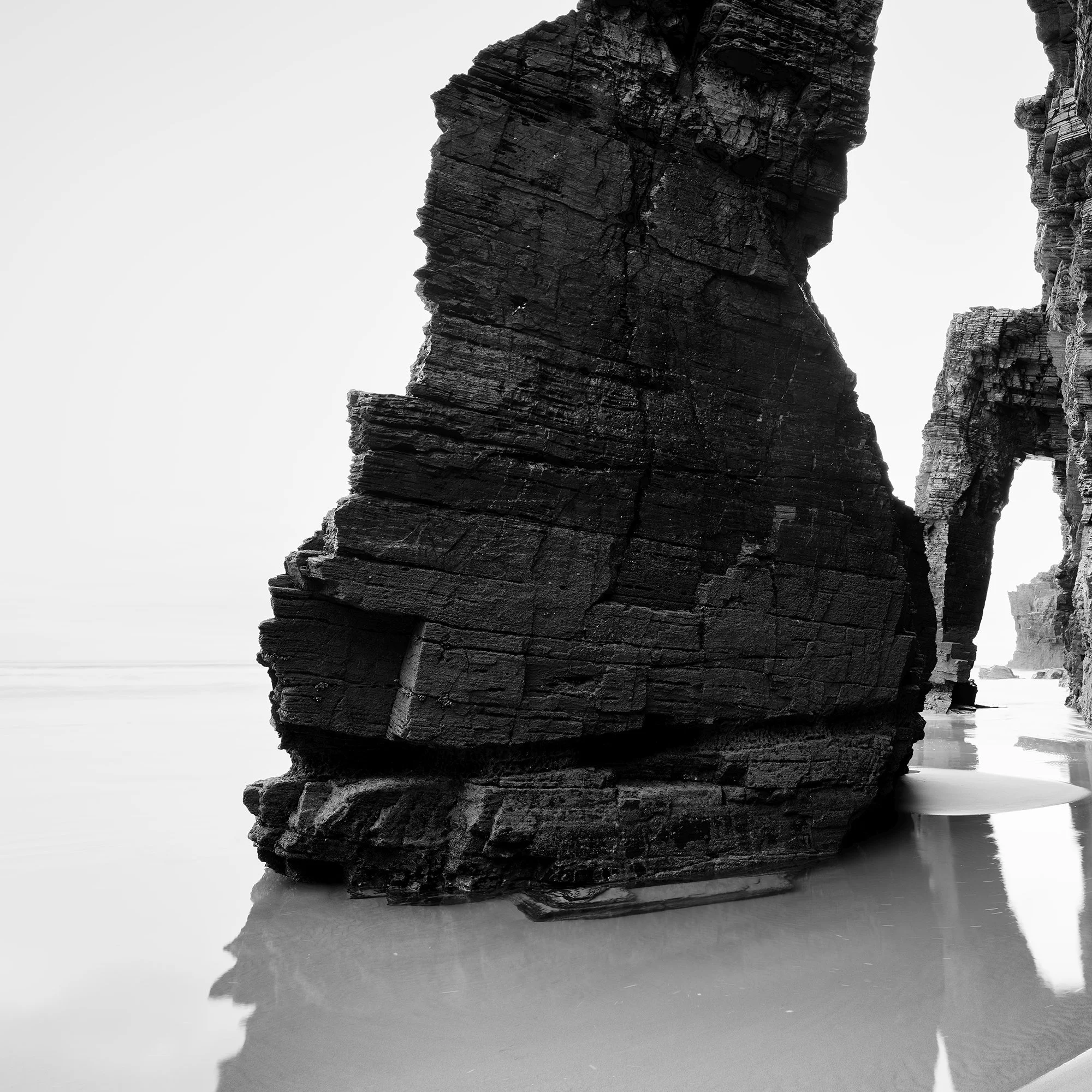 Detail of Arches on Catedrais Beach Study 4 showing layered coastal rock formations and wet sand reflections in Galicia, Spain.