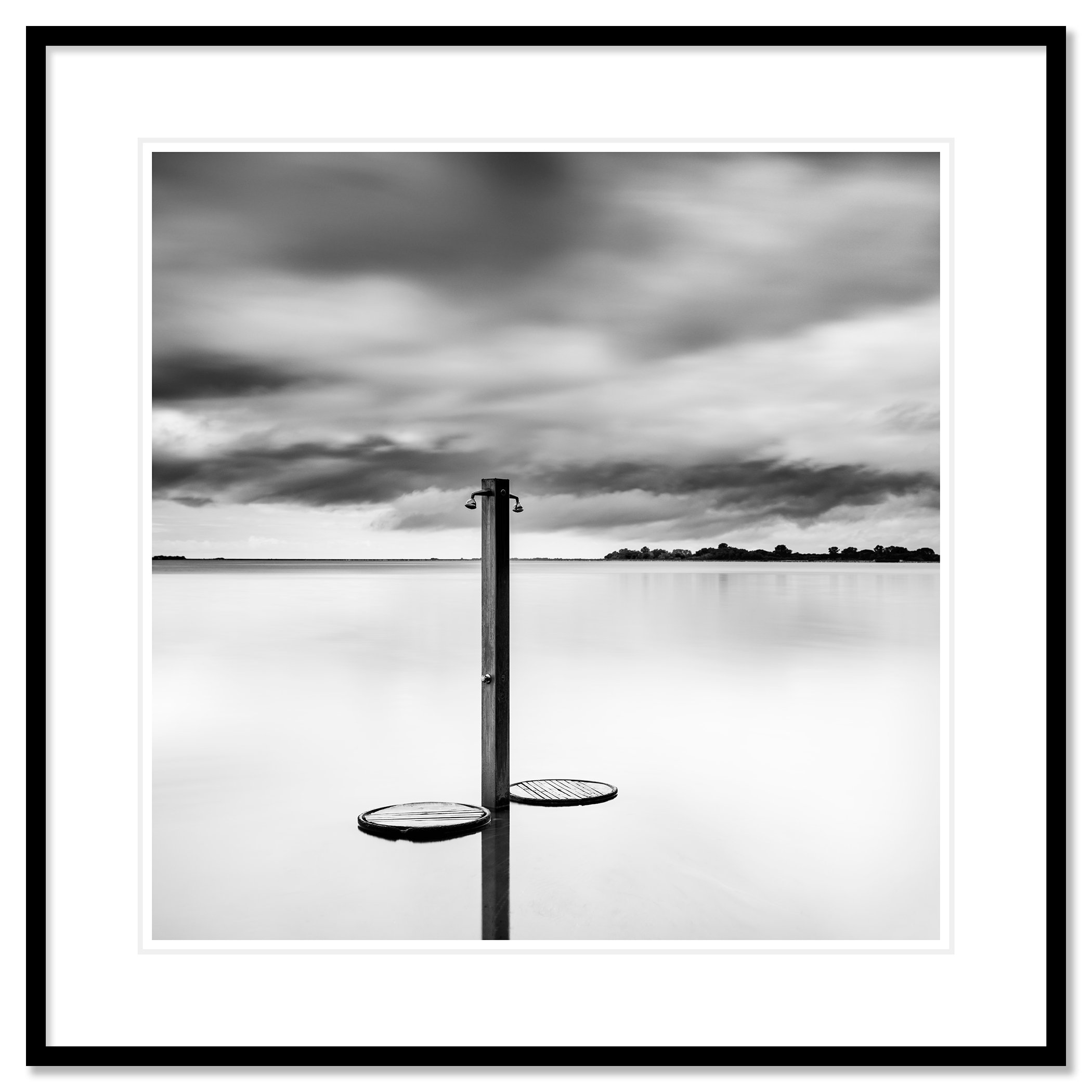 Beach Shower in a Storm – archival black-and-white fine art print in a black aluminium frame with a white mount by Gerald Berghammer.