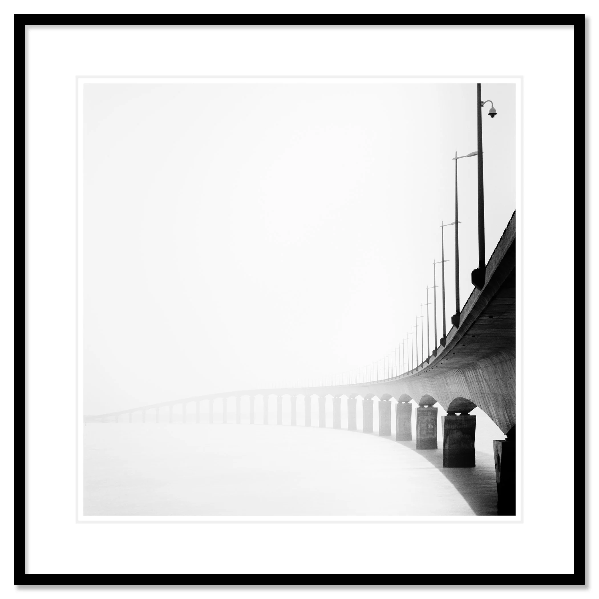 Pont de l’Île de Ré Study 1 as an archival pigment print in a black aluminium frame with a white mount by Gerald Berghammer.