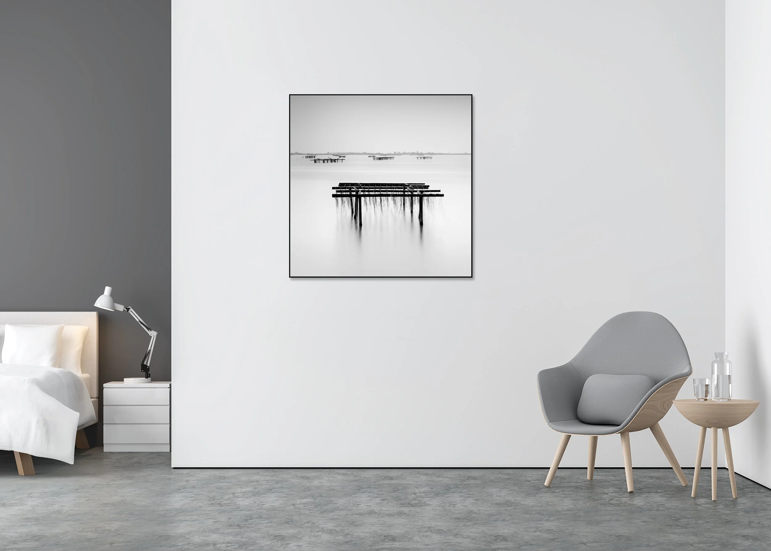 Long-exposure black-and-white coastal print with wooden fishing racks, calm water and distant shoreline, mounted to Dibond in an aluminium ArtBox.