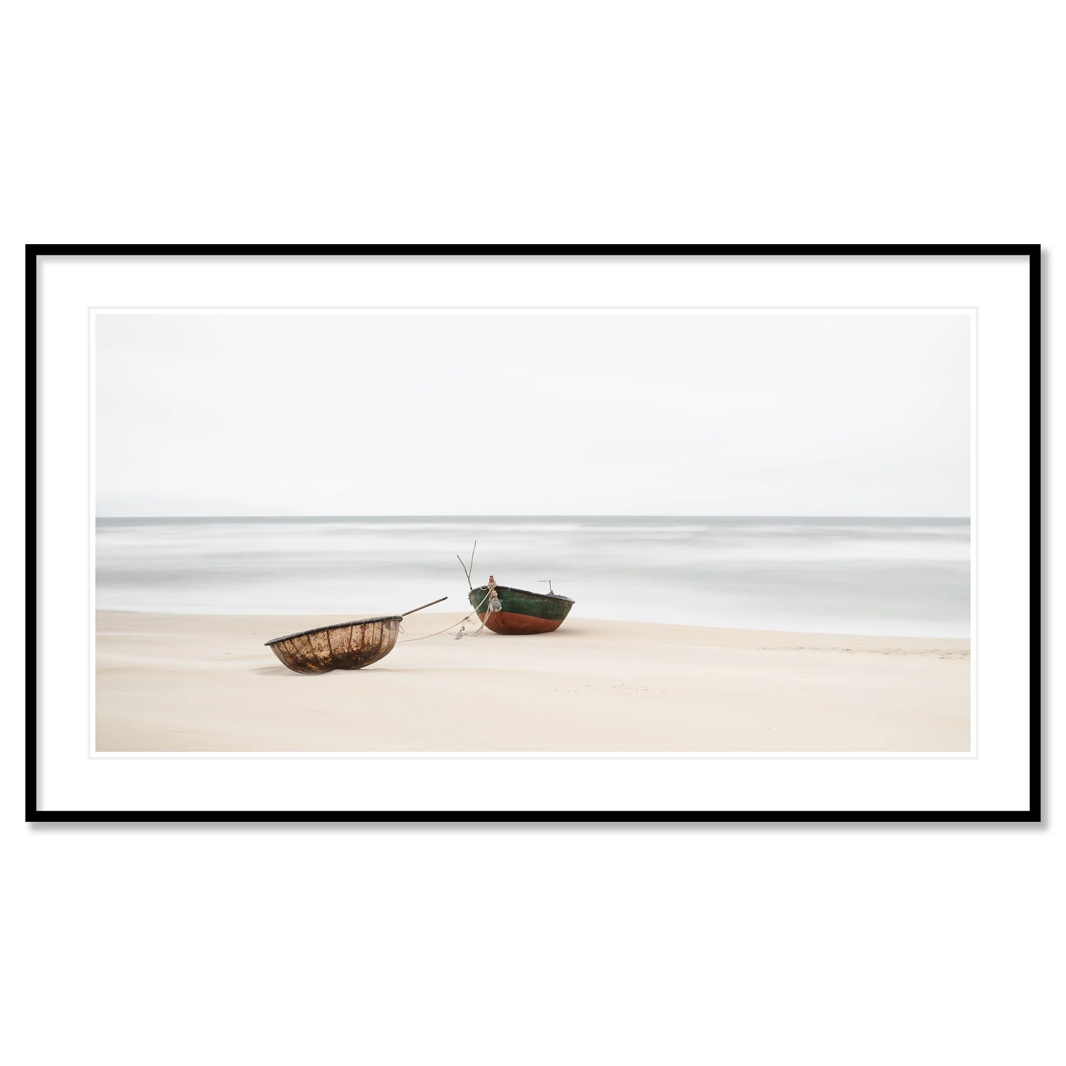 Gerald Berghammer - Color long exposure panorama photography. Two boats resting on a sandy beach near the ocean with calm waves and a cloudy sky. Classic framed black