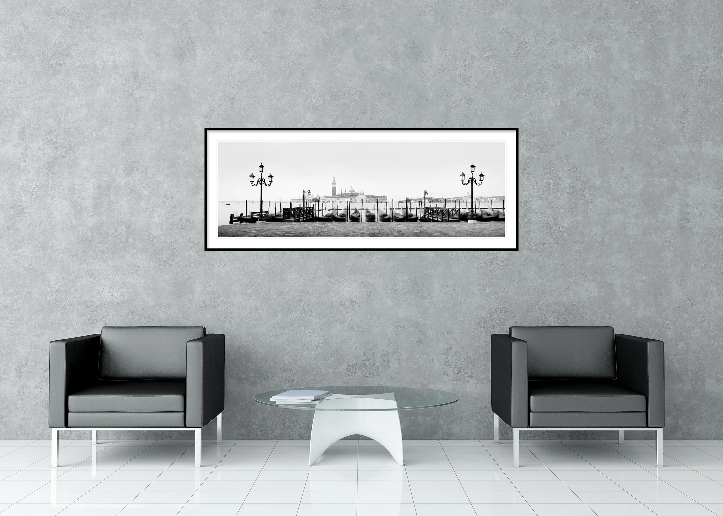 Panoramic black and white view of Venice with moored gondolas, ornate lampposts and San Giorgio Maggiore across the lagoon, archival pigment print in a classic frame with mount.
