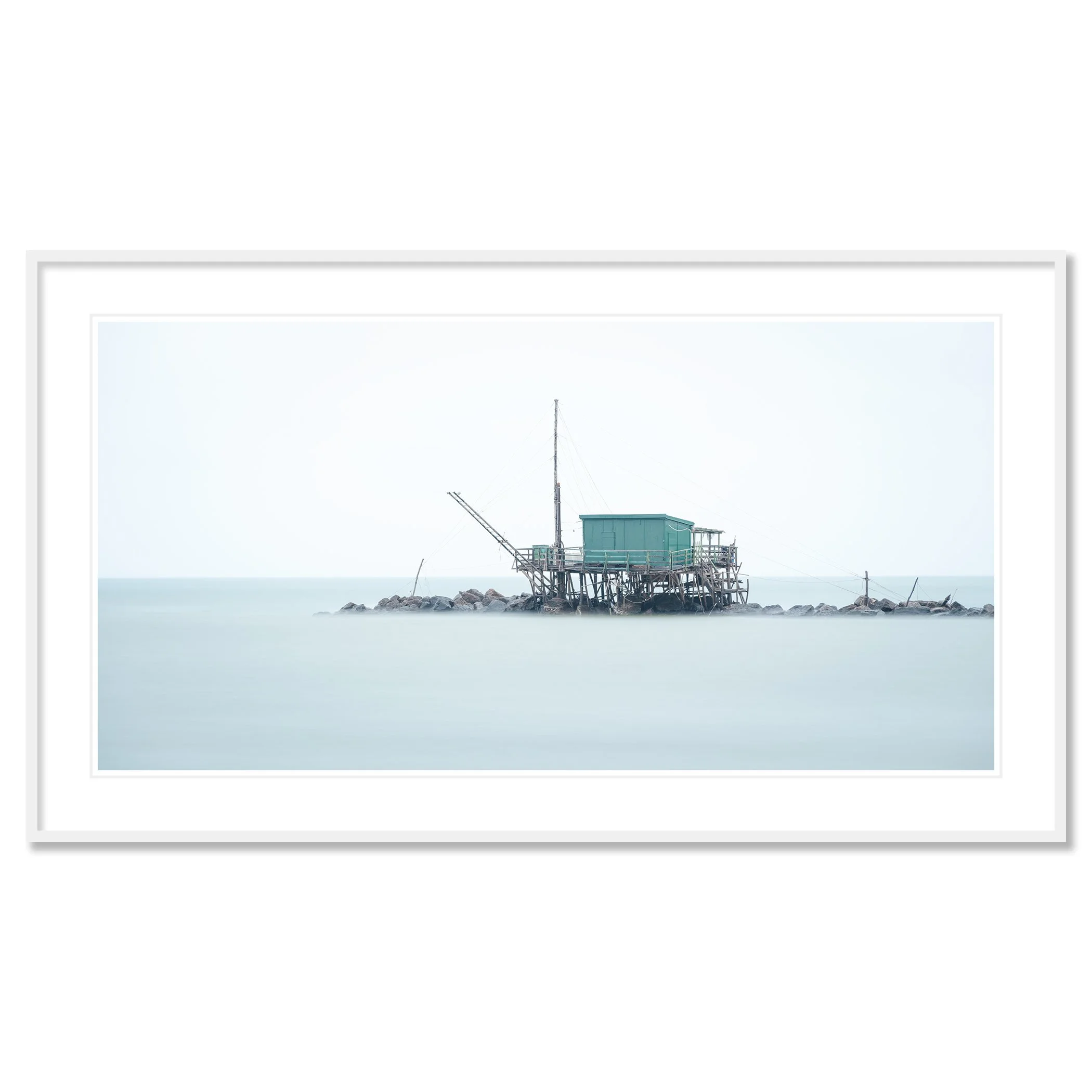 © 2024 Gerald Berghammer - Color minimalist photography. A small house built on stilts over water on rocks, with a fishing pole, in a minimalist, misty seascape. Classic framed white