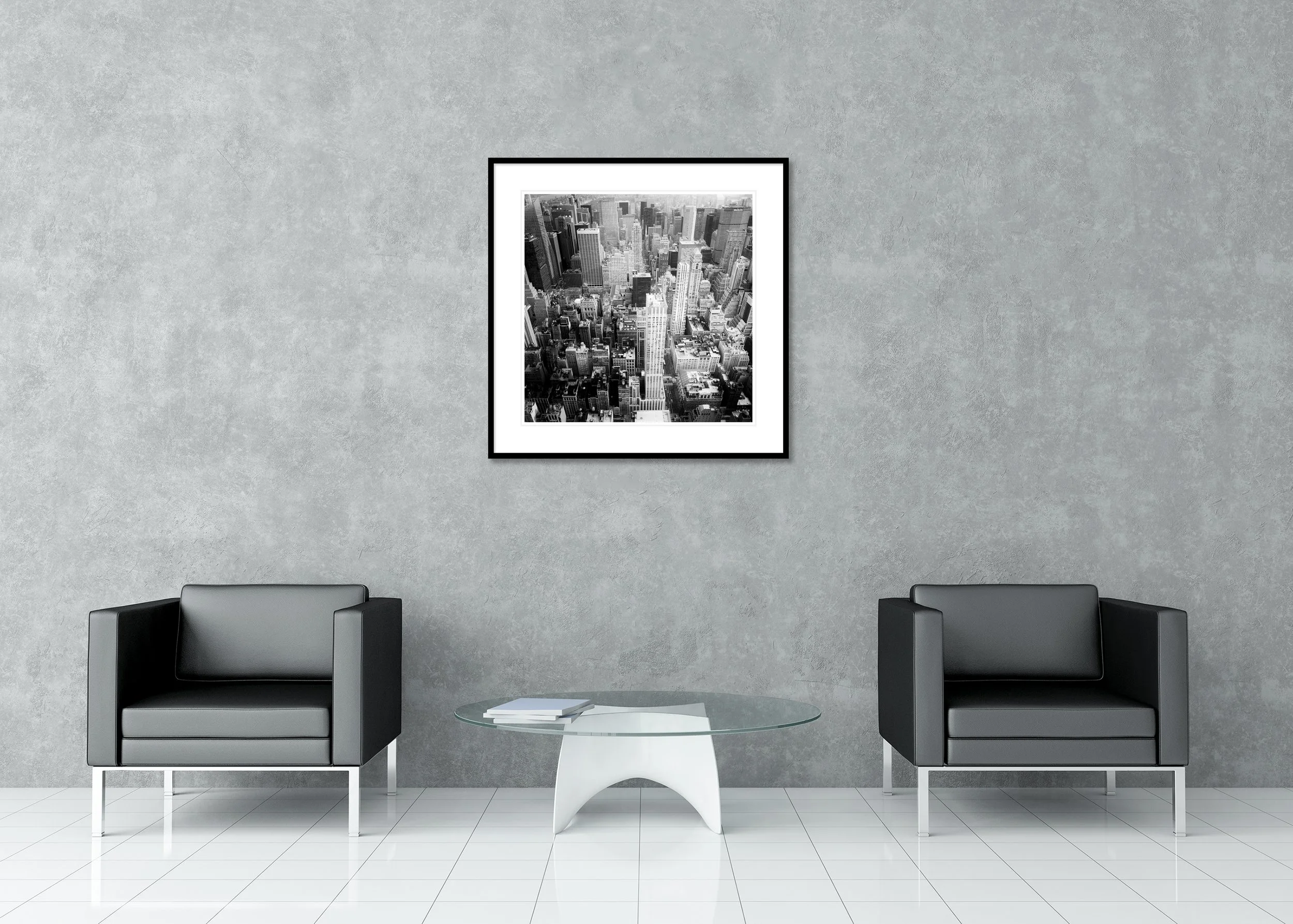 Black-and-white aerial photo of the NYC skyline with modern high-rise architecture and dense streets, archival pigment print in a classic frame with mount.