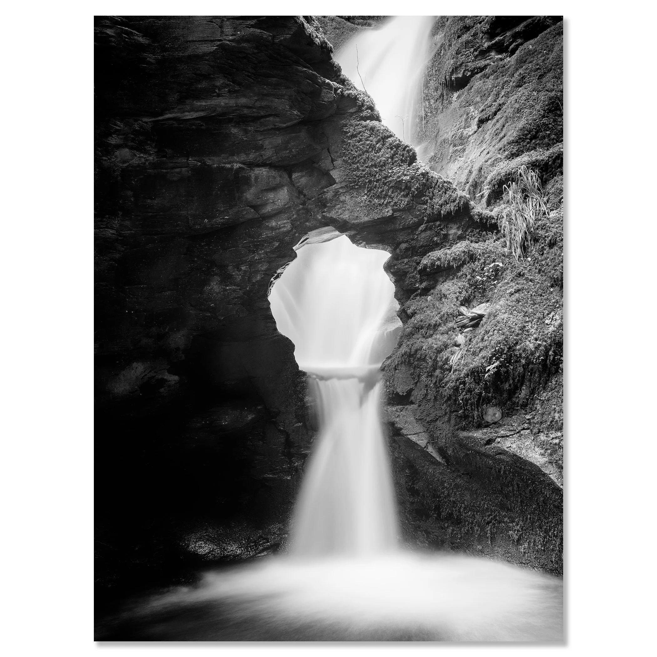 Fine art black and white waterfall print with silky water, rugged rock formations and moss-covered cliffs – dibond frameless