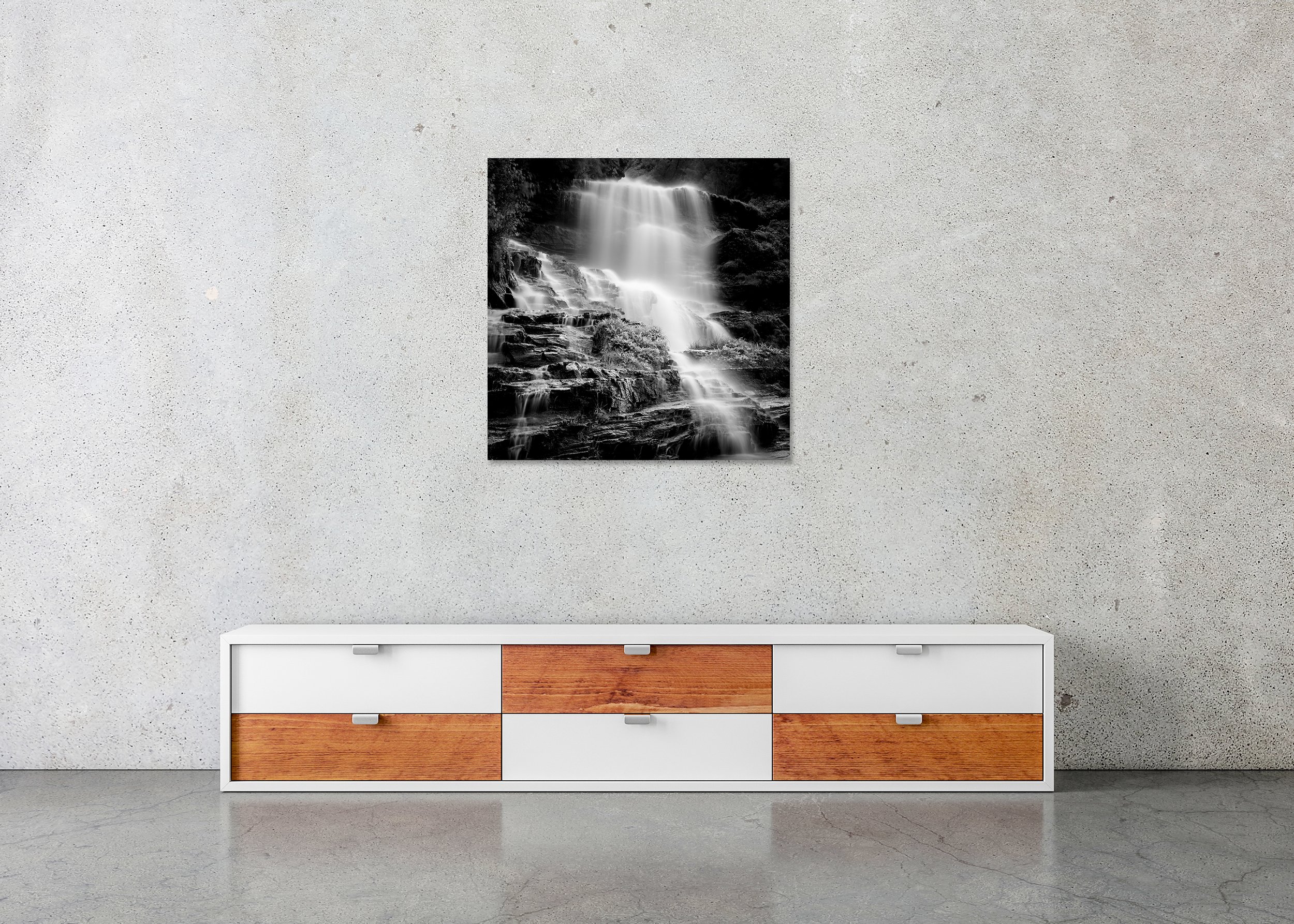 Black-and-white cascading waterfall with long-exposure misty water over dark rocks, photo print mounted to Dibond, frameless.