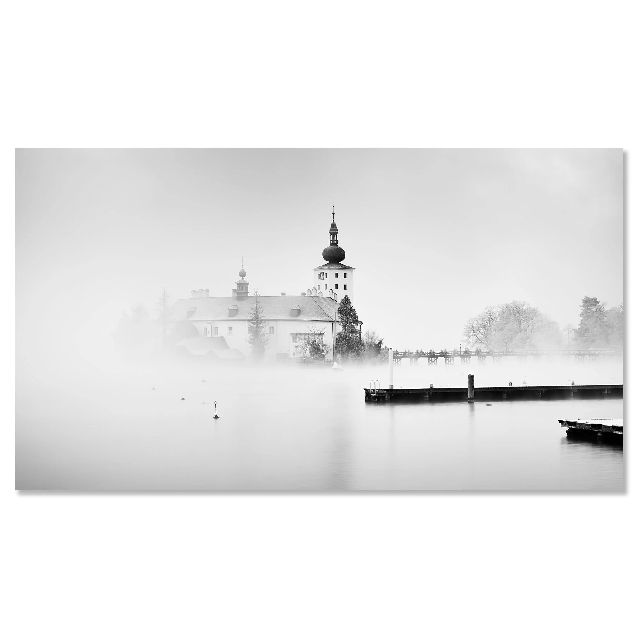© 2022 Gerald Berghammer - Black and white cityscape photography. Schloss Ort - The historic church surrounded by mist over a lake with docks in the foreground. Chromaluxe frameless