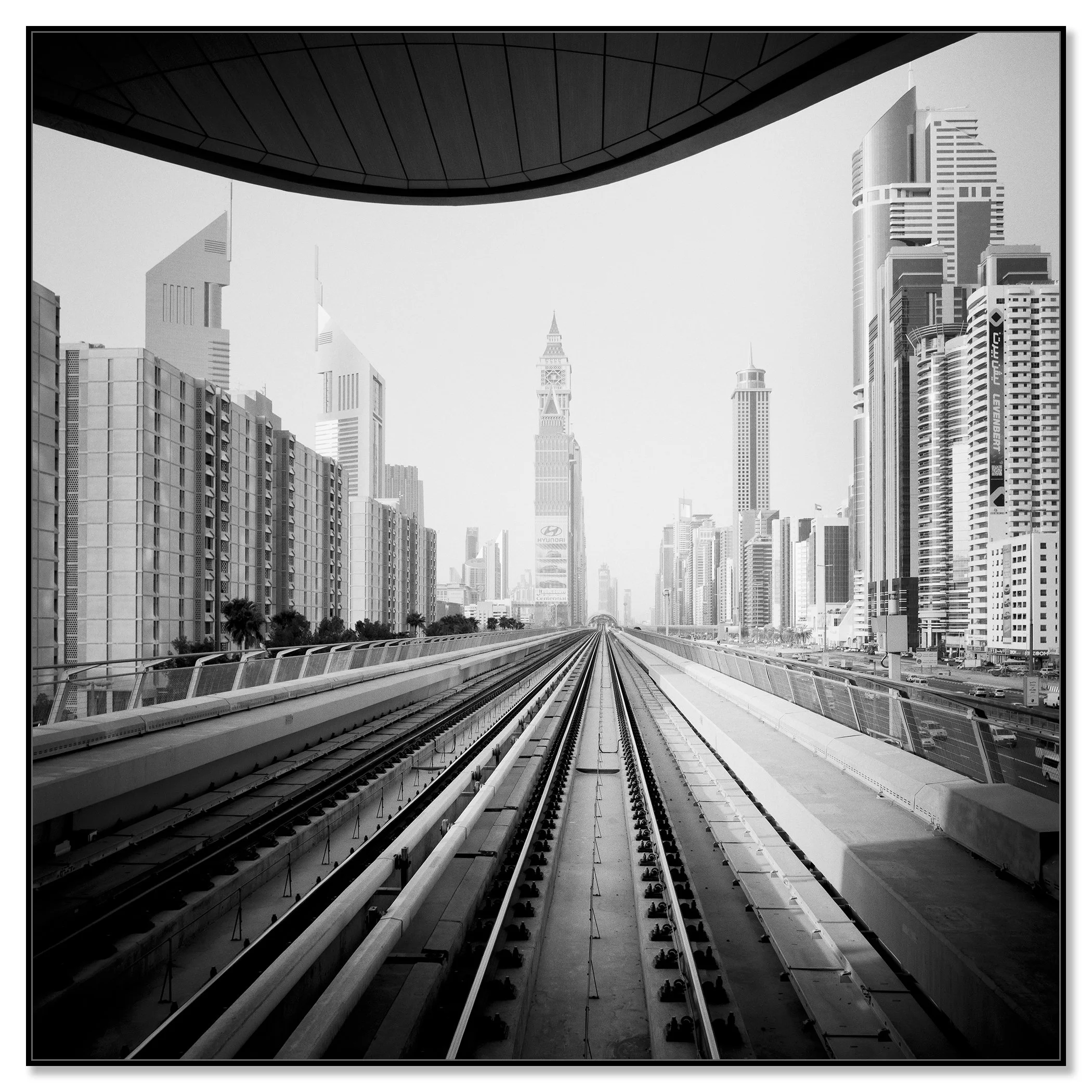 Surreal World mounted on aluminium Dibond in a black ArtBox frame, featuring Dubai’s Metro tracks and skyscraper skyline by Gerald Berghammer.