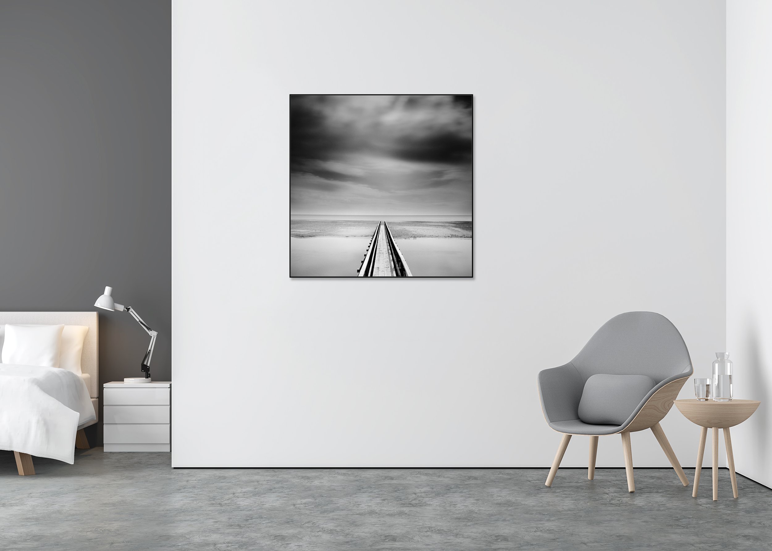 Black-and-white photo print of a long wooden pier over still water under moody clouds, mounted to Dibond in an aluminium ArtBox.
