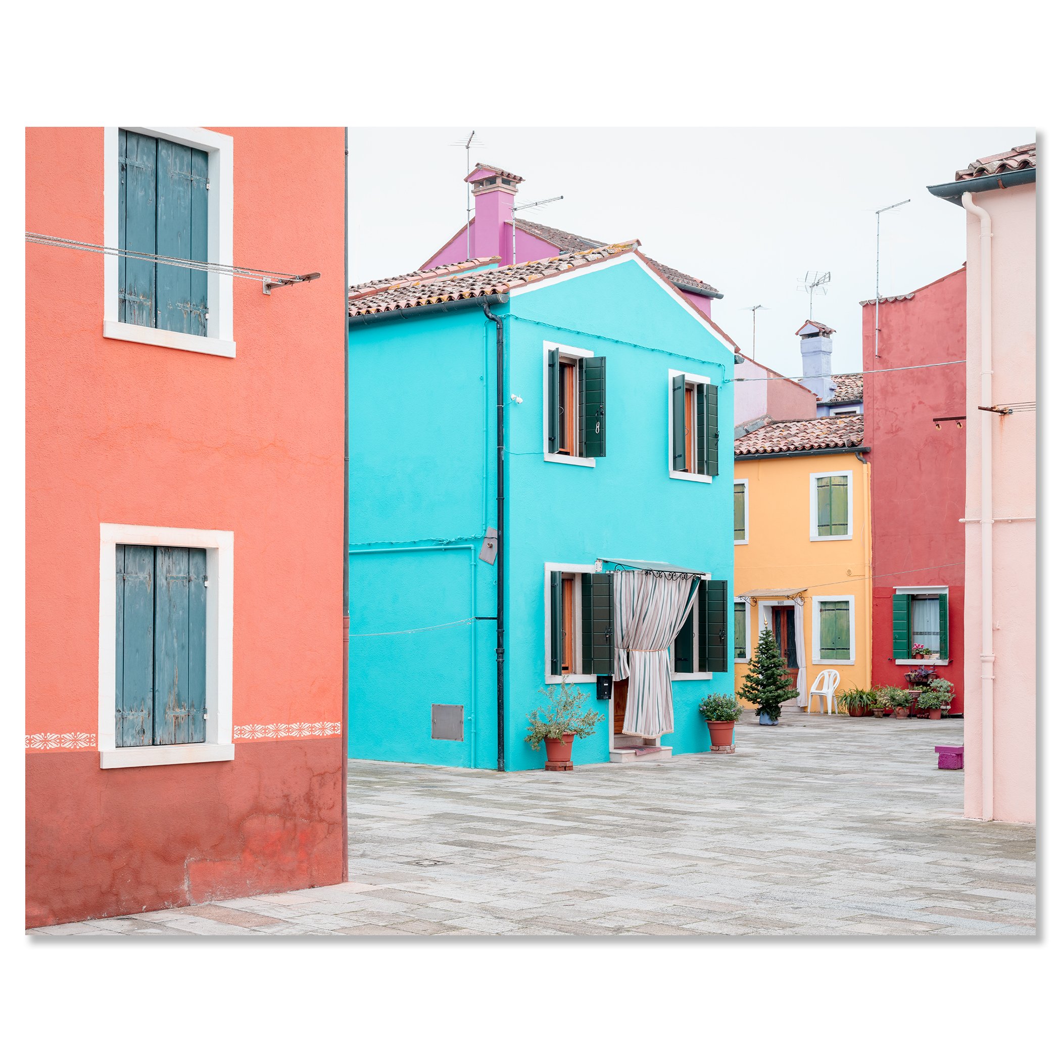 © 2025 Gerald Berghammer - Color cityscape photography. Colorful buildings with pastel pink, blue, yellow, and red walls, windows, and open shutters in a courtyard. Chromaluxe frameless