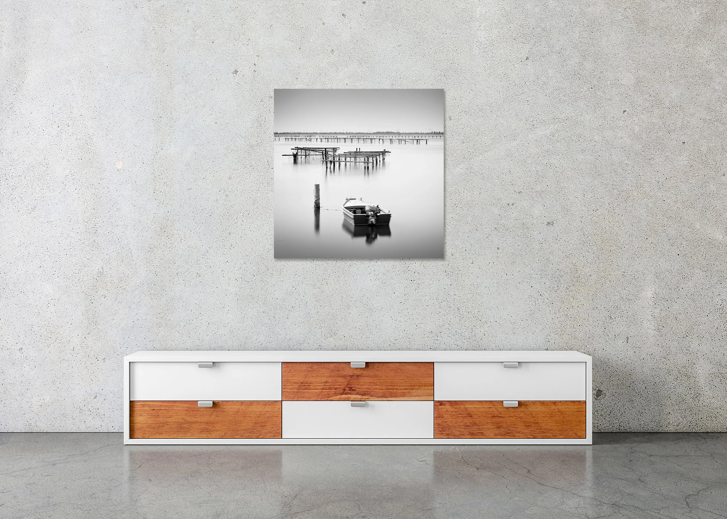 Small boat moored on calm water in Italy, black-and-white seascape with wooden aquaculture piers, photo print mounted to Dibond, frameless