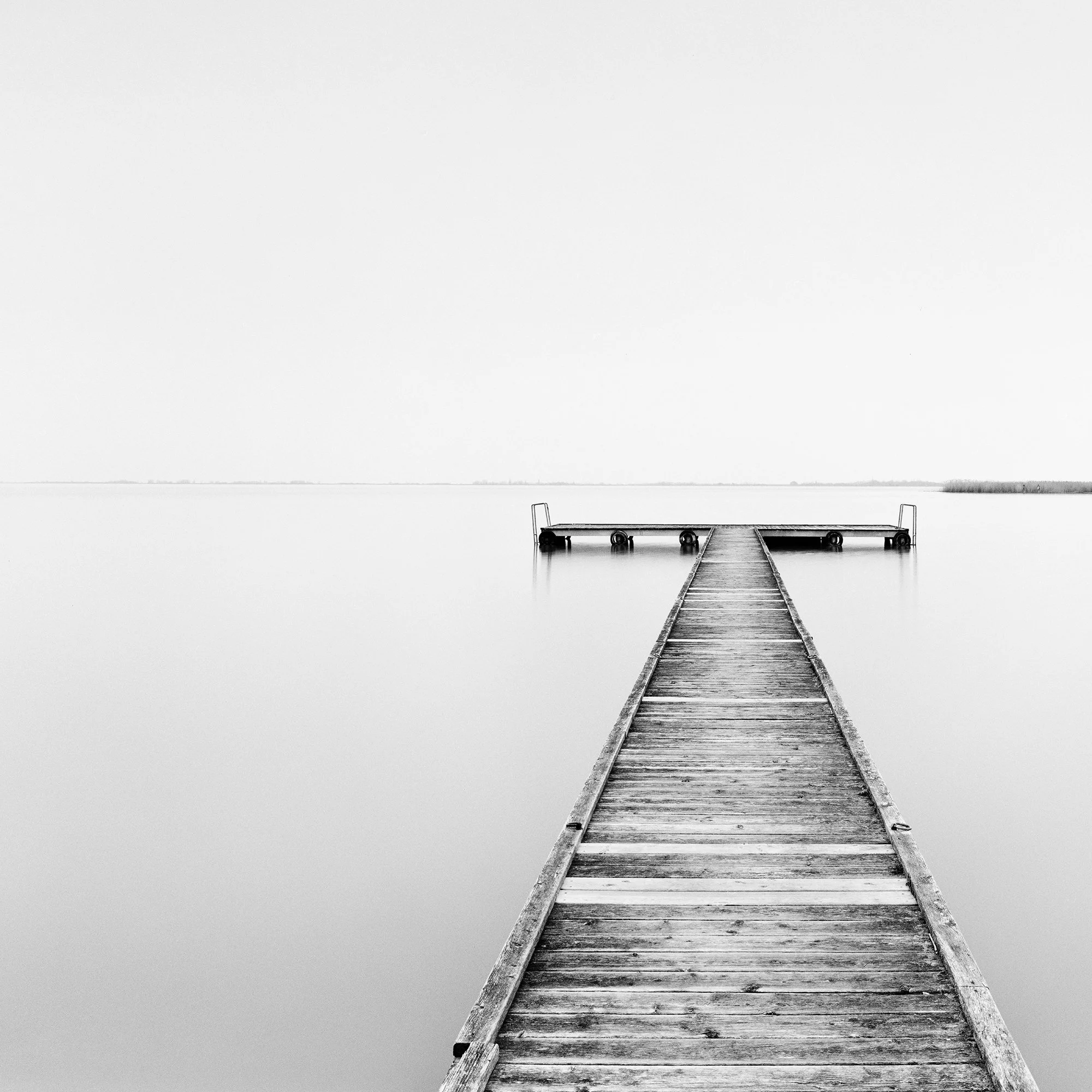 Cropped view of Pier Study 1, a minimalist black-and-white waterscape of Lake Neusiedl by Gerald Berghammer.