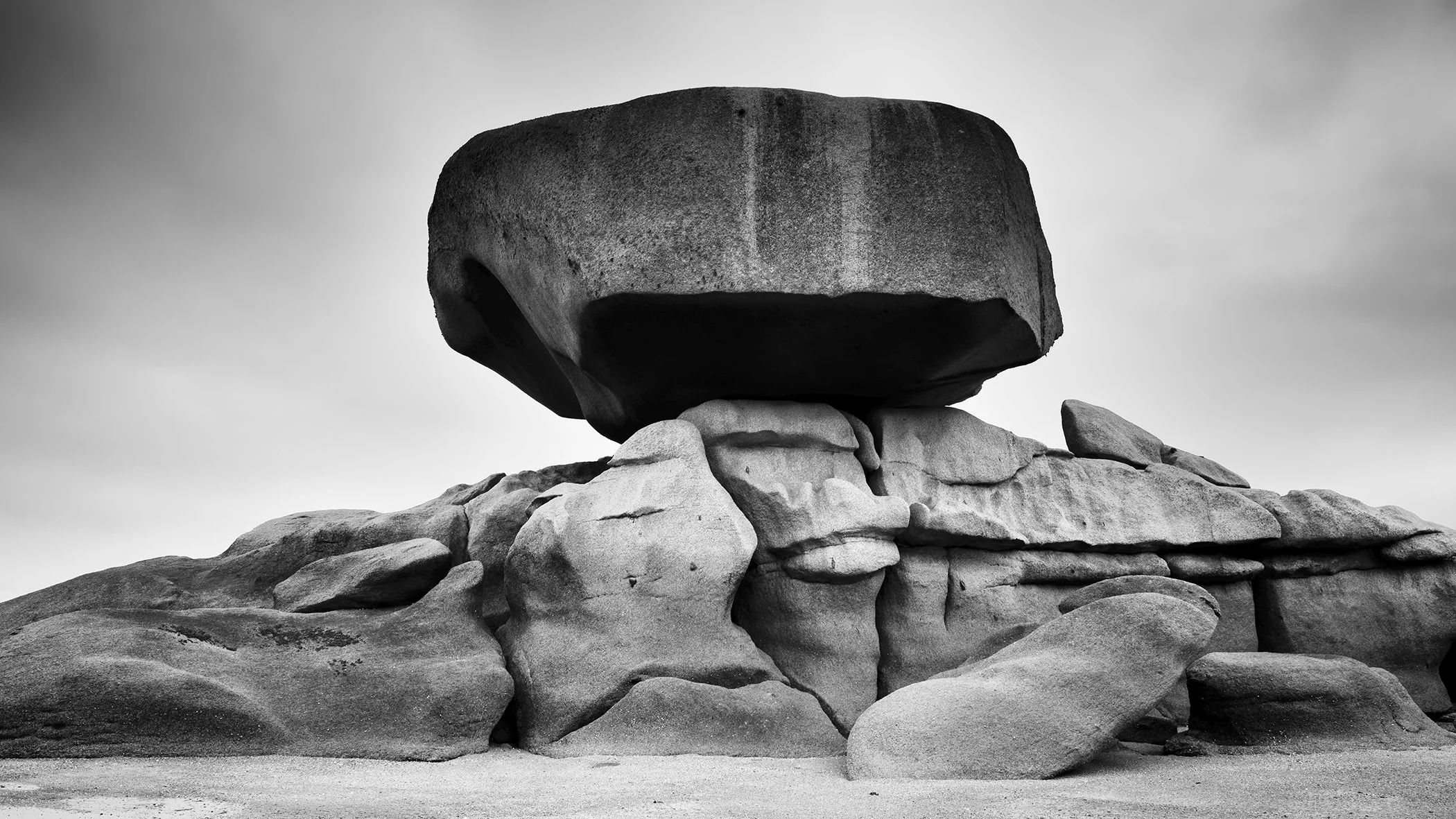 Pink Granite Coast Panorama Study 2 by Gerald Berghammer, minimalist black-and-white landscape photograph of a monumental balanced granite boulder on the Pink Granite Coast in Brittany, France.