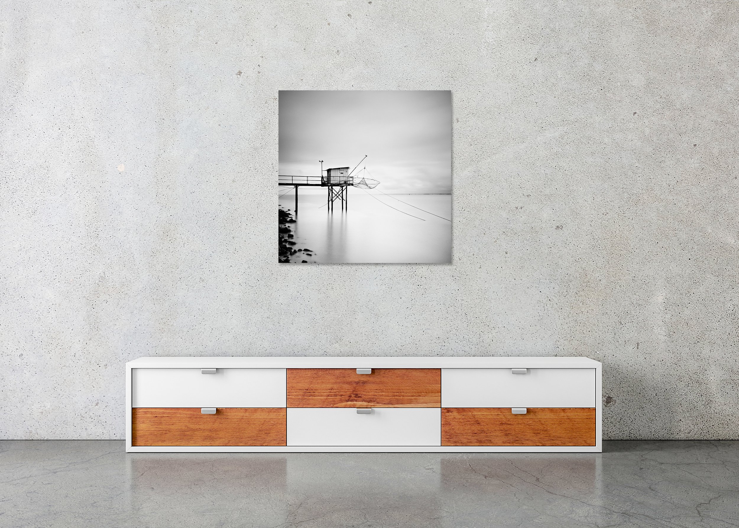Minimalist black-and-white long-exposure of a traditional fishing hut on stilts with nets over a calm sea, photo print mounted on Dibond, frameless