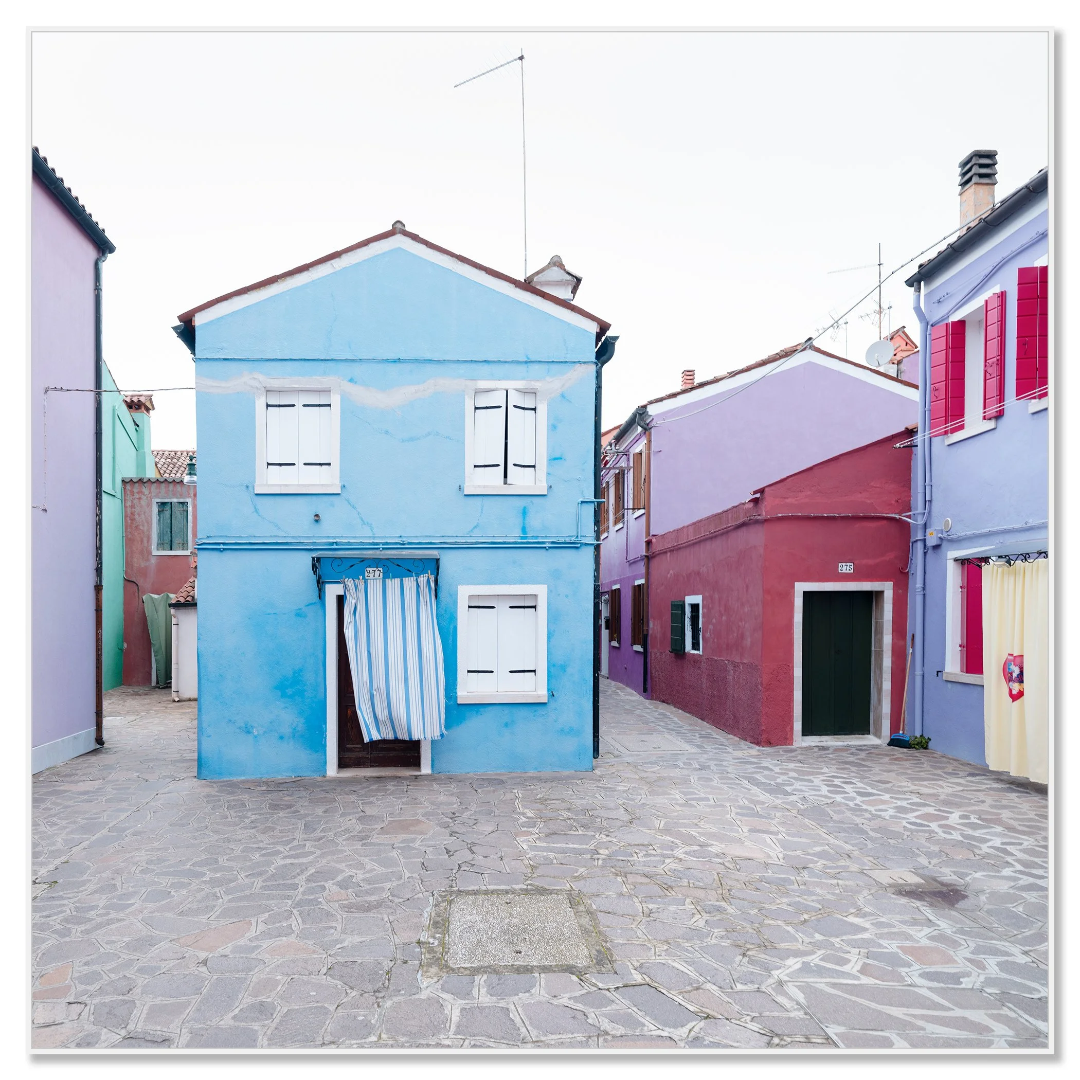 Traditional colourful houses in Burano, Venice, with shutters and a cobbled walkway – framed ArtBox white