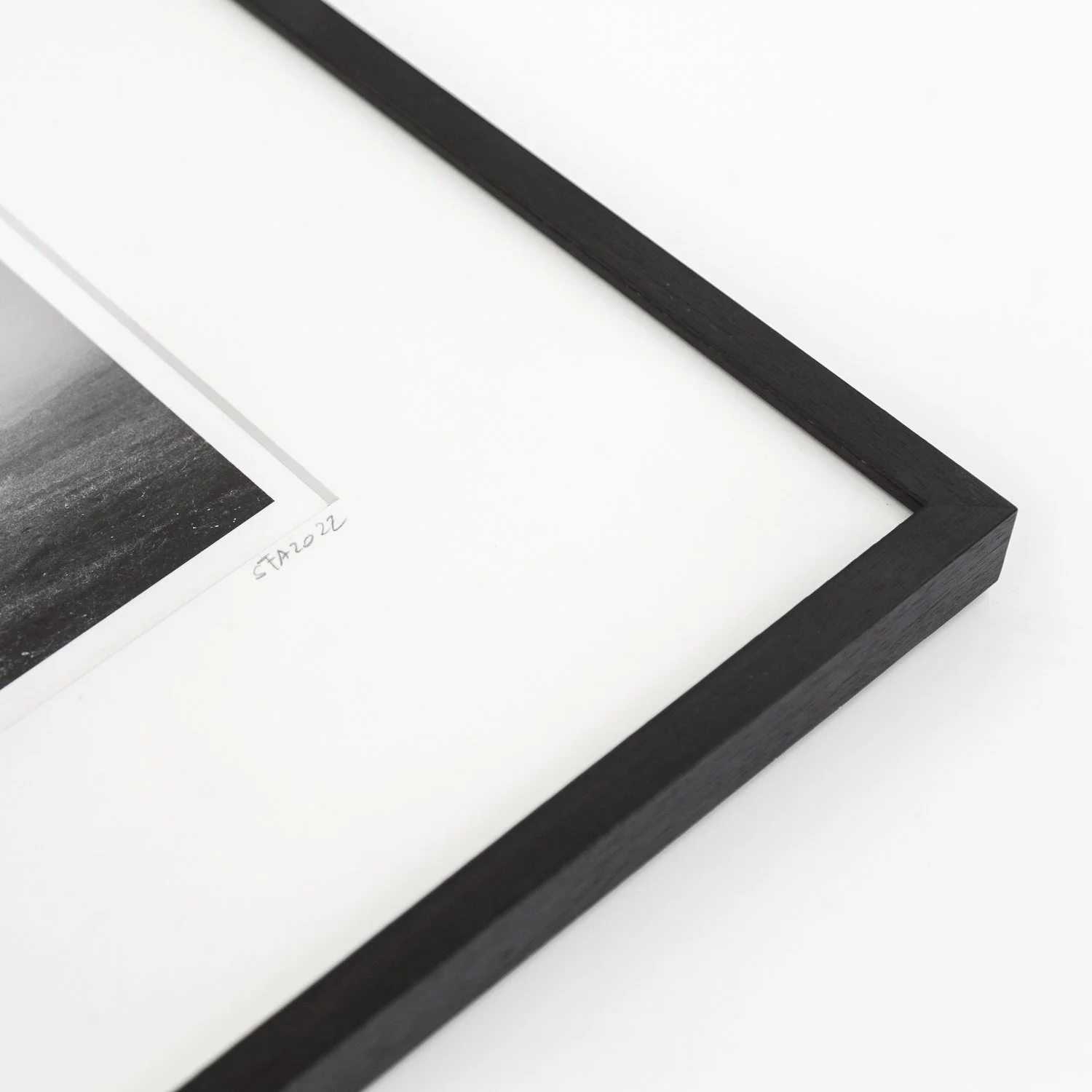 Detail of Gerald Berghammer's dated fine art print, showing the natural-white archival mount and handmade black frame.