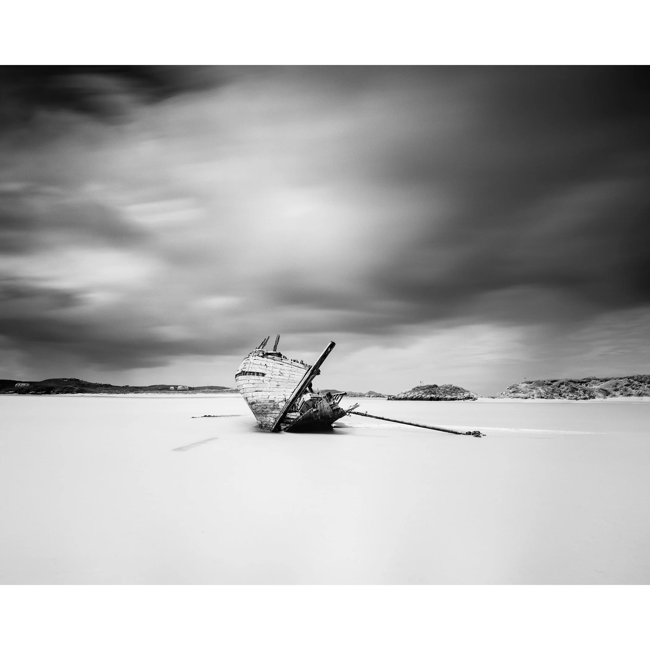 Minimalist black-and-white long-exposure photograph of Bad Eddie’s shipwreck on the Irish coast by Gerald Berghammer.
