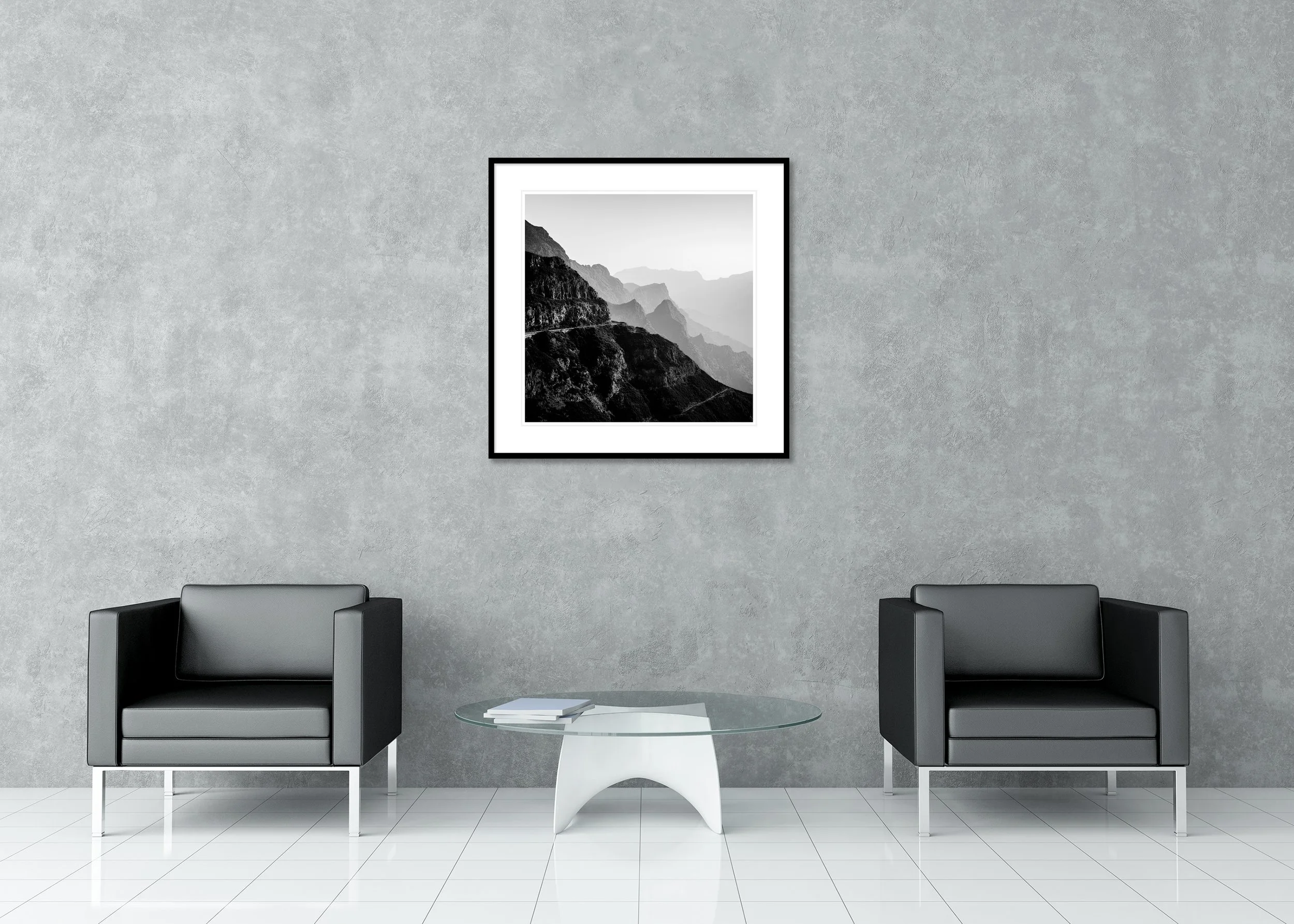 Black and white photo of dramatic mountain slopes and a curving road, archival pigment print in a classic frame with a mount.